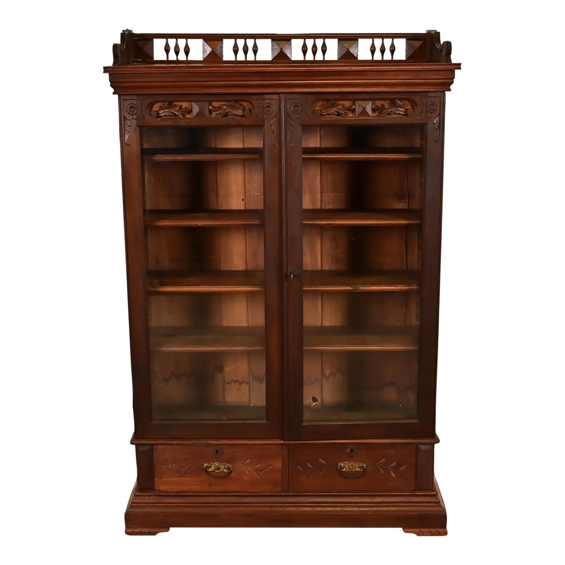 Herter Brothers Style Antique Eastlake Victorian Carved Walnut Bookcase, Circa 1880s: An exceptional antique Eastlake Victorian bookcase cabinet In the manner of Herter Brothers USA, Circa 1880s Carved walnut, with glass front doors, and original hardware. Measures: 44.25"W x 15"D x 66