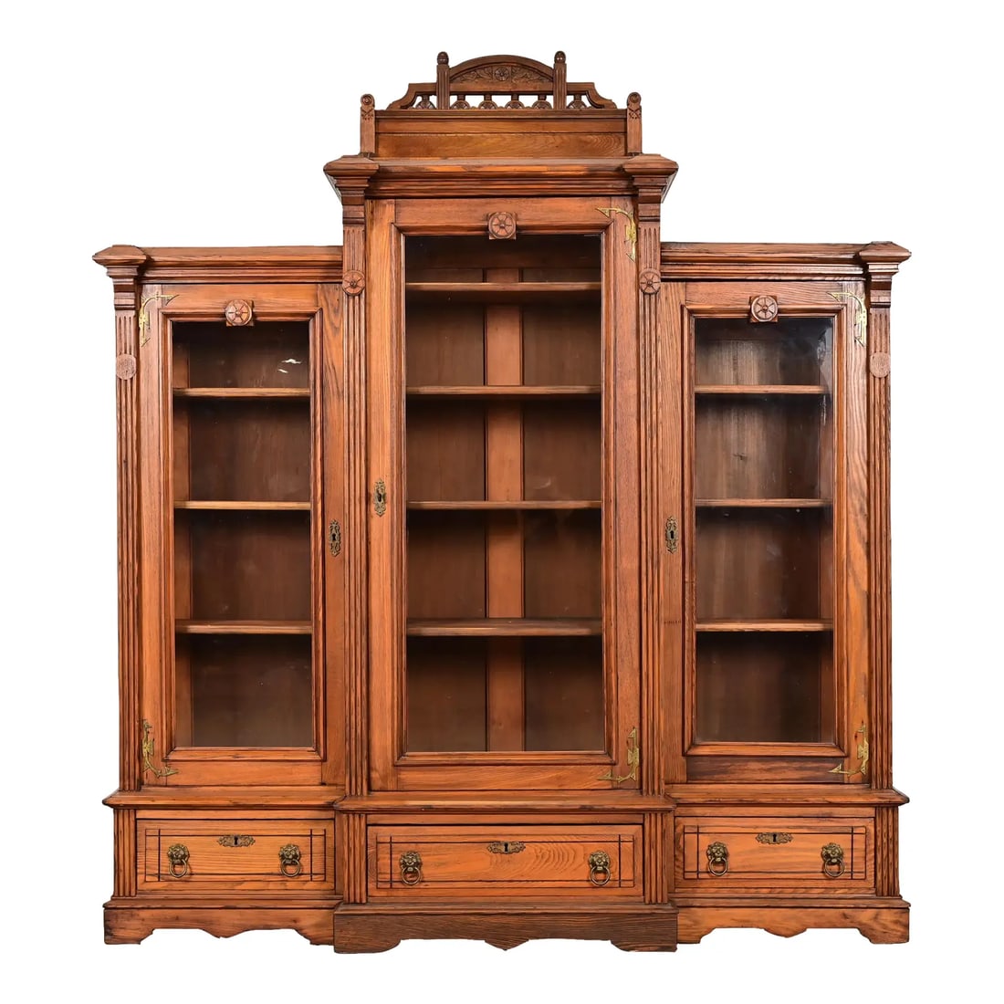 Herter Brothers Style Antique Eastlake Victorian Carved Oak Triple Bookcase Cabinet, Circa 1880s: A gorgeous antique Eastlake Victorian or Renaissance Revival triple bookcase cabinet or display cabinet In the manner of Herter Brothers USA, Late 19th Century Carved oak, with glass front doors, and 