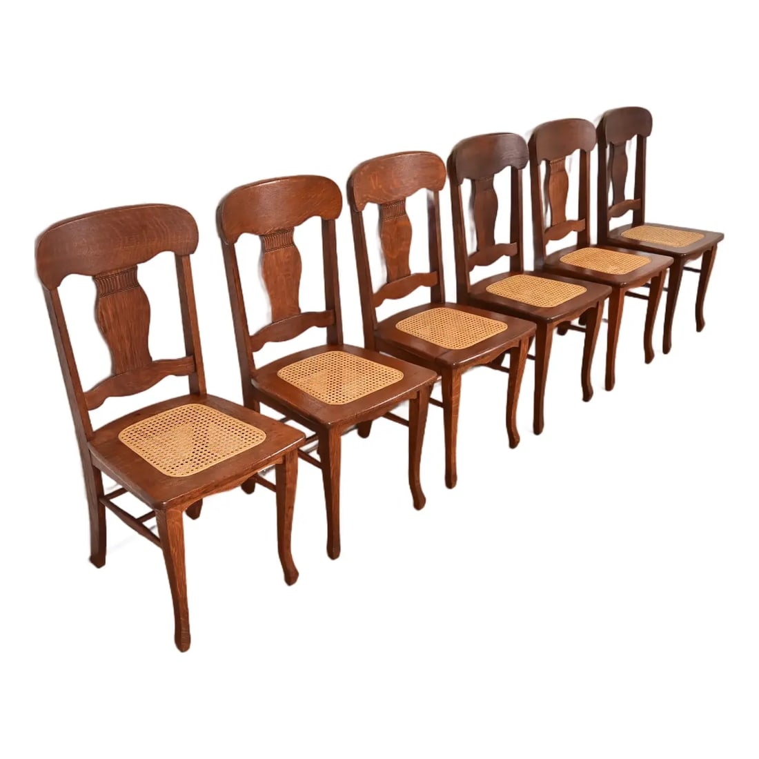 Limbert Style Antique Arts & Crafts Carved Oak and Cane Dining Chairs, Set of Six: A gorgeous set of six Arts & Crafts period dining chairs or side chairs In the manner of Charles P. Limbert Co. USA, Early 20th Century Carved quarter sawn oak, with cane seats. Measures: 17.25"W x 20