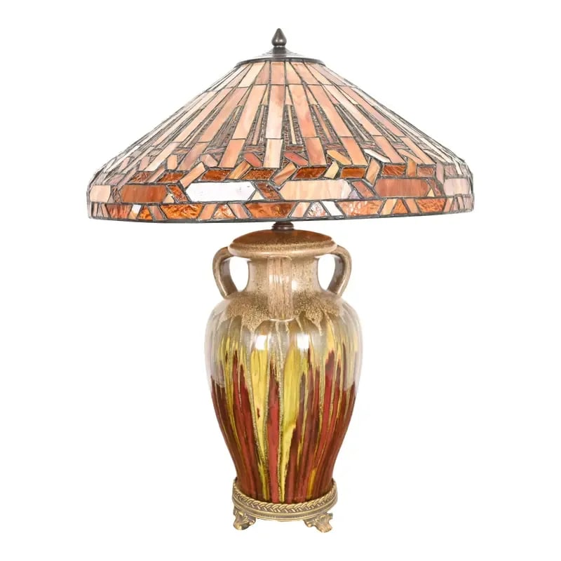 Tiffany Style Arts & Crafts Ceramic Table Lamp With Stained Glass Shade: A gorgeous Arts & Crafts style table lamp Circa Late 20th Century Urn form glazed ceramic base, with stained glass shade. Measures: 20.25"W x 20.25"D x 27"H. Very good original vintage condition. See 