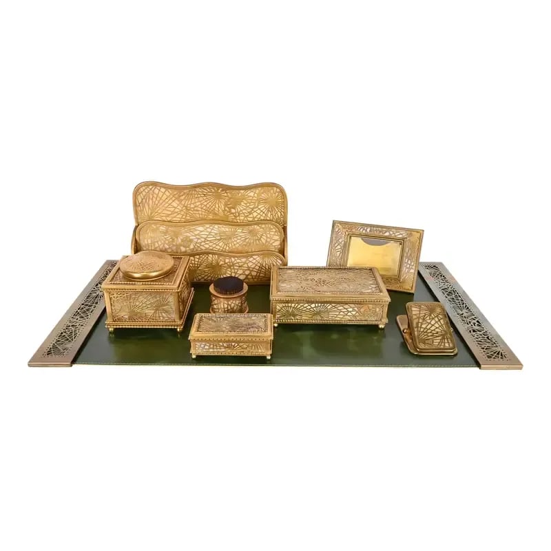 Tiffany Studios New York Pine Needle Bronze Doré and Slag Glass Eight-Piece Desk Set, Circa 1910: A gorgeous antique Arts & Crafts or Art Nouveau period "Pine Needle" gilt bronze and Favrile slag glass desk set. The eight-piece set includes: inkwell, pen brush, letter rack, calendar frame, large d