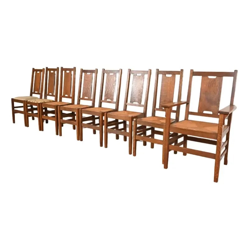 Gustav Stickley Antique Mission Oak Arts & Crafts H-Back Dining Chairs With Rush Seats, Set of Eight: A rare set of eight Mission oak Arts & Crafts period H-back dining chairs By Gustav Stickley USA, Early 20th Century Solid quarter sawn oak, with rush seats and upholstery. Measures: Side Chairs - 16.