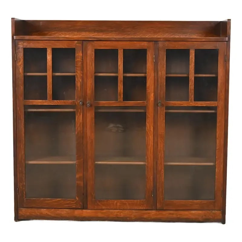 Limbert Antique Mission Oak Arts and Crafts Triple Bookcase Cabinet, Circa 1900: A beautiful antique Mission or Arts & Crafts period triple bookcase cabinet By Charles P. Limbert Co. USA, Circa 1900 Quarter sawn oak, with mullioned glass front doors, and original copper hardware. 
