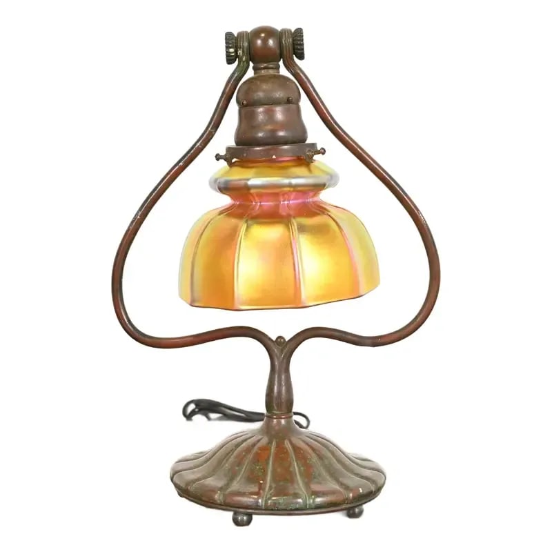 Tiffany Studios New York Bronze Harp Favrile Iridescent Art Glass Desk Lamp: A gorgeous Arts & Crafts or Art Deco period bronze harp desk lamp or table lamp By Tiffany Studios (base signed to the underside) New York, USA, Early 20th Century Patinated bronze base, with beautifu