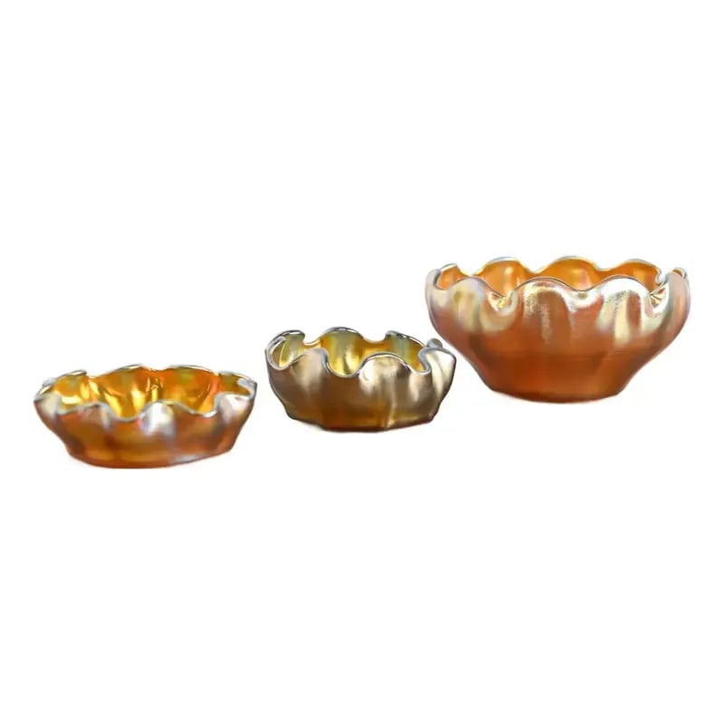Louis Comfort Tiffany Favrile Iridescent Art Glass Salt Cellars With Ruffled Edges, Set of Three: A gorgeous set of three Arts & Crafts or Art Nouveau period Favrile iridescent art glass finger bowls or salt cellars with ruffled edges By Louis Comfort Tiffany for Tiffany Studios (signed to the und