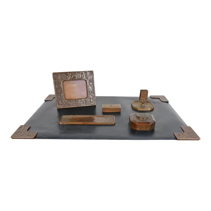 Tiffany Studios New York Zodiac Bronze Six-Piece Desk Set, Circa 1910: An outstanding Art & Crafts or Art Deco period "Zodiac" patinated bronze desk set. The six-piece set includes: picture frame, stamp box, inkwell, pen tray, match stand, and set of four blotter corners