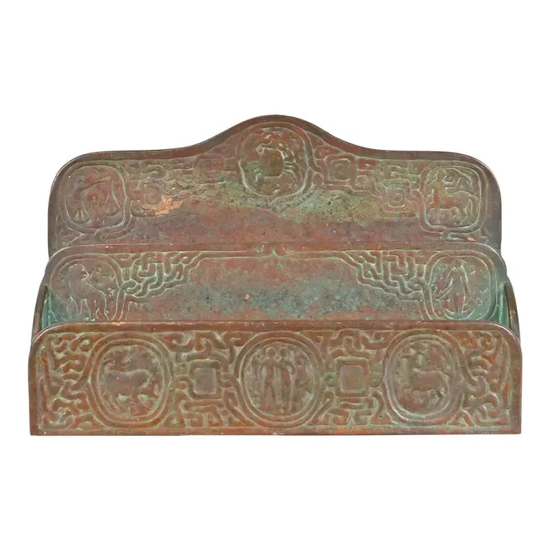 Tiffany Studios New York Zodiac Patinated Bronze Letter Rack, Circa 1910: A gorgeous antique patinated bronze desk letter rack featuring Zodiac designs By Tiffany Studios (signed to the back) New York, USA, Early 20th Century Measures: 9.63"W x 2.5"D x 6.25"H Good original 