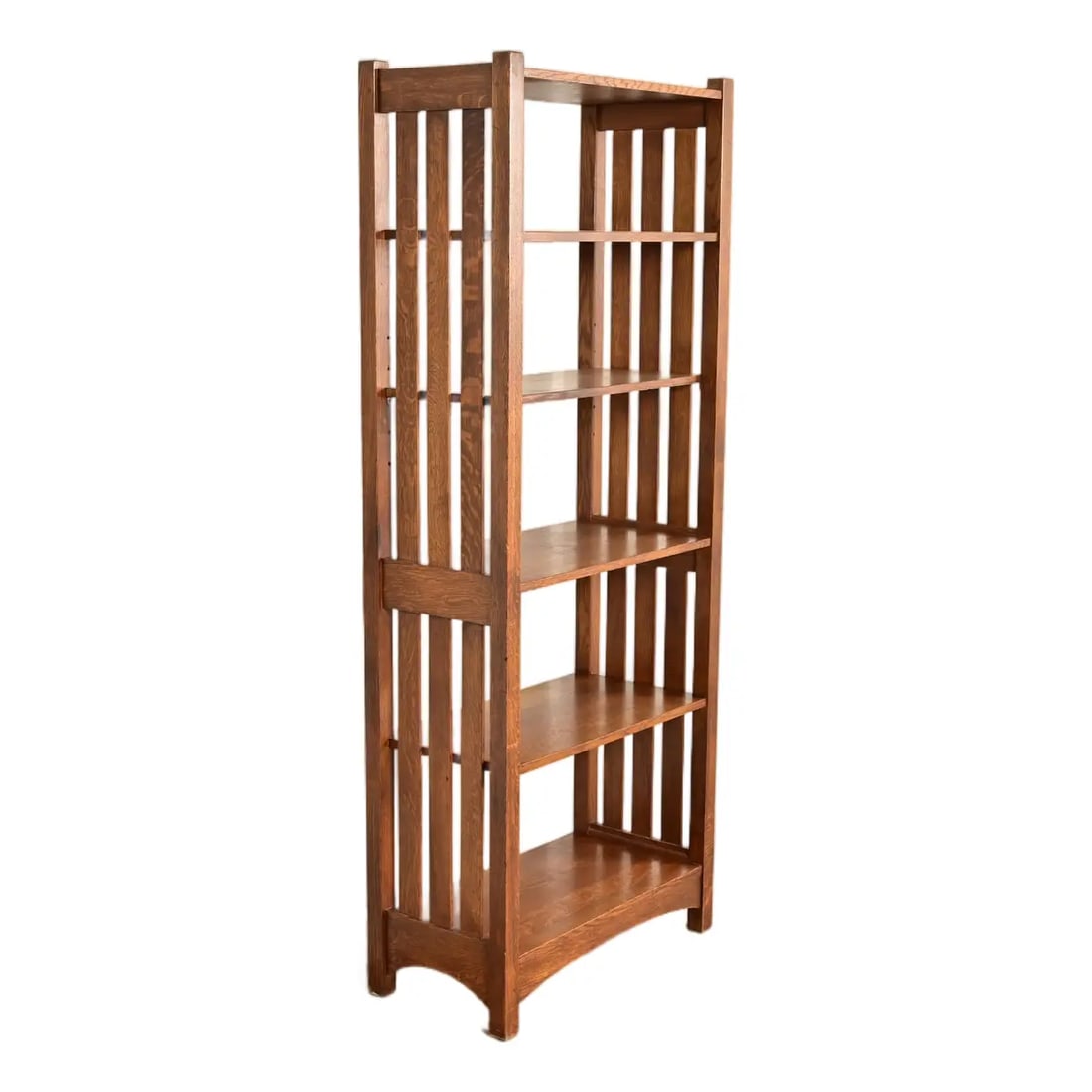 Stickley Mission Oak Arts & Crafts Slatted Tall Bookcase: An exceptional Mission or Arts & Crafts quarter sawn oak tall bookcase By Stickley USA, Circa Late 20th Century Measures: 30"W x 15.25"D x 76"H. Very good original vintage condition. Two matching book