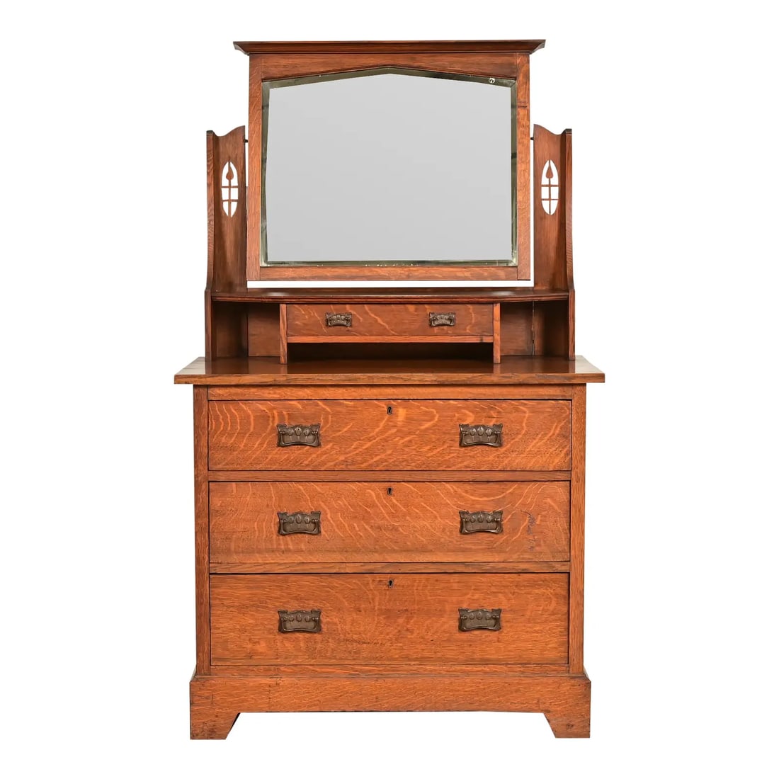 Liberty & Co. Antique English Mission Oak Arts & Crafts Vanity Dresser With Mirror, Circa 1900: A gorgeous antique Mission, Arts & Crafts, or Art Nouveau period four-drawer vanity dresser or chest of drawers with mirror Attributed to Liberty & Co. England, Circa 1900 Gorgeous quarter sawn tiger 