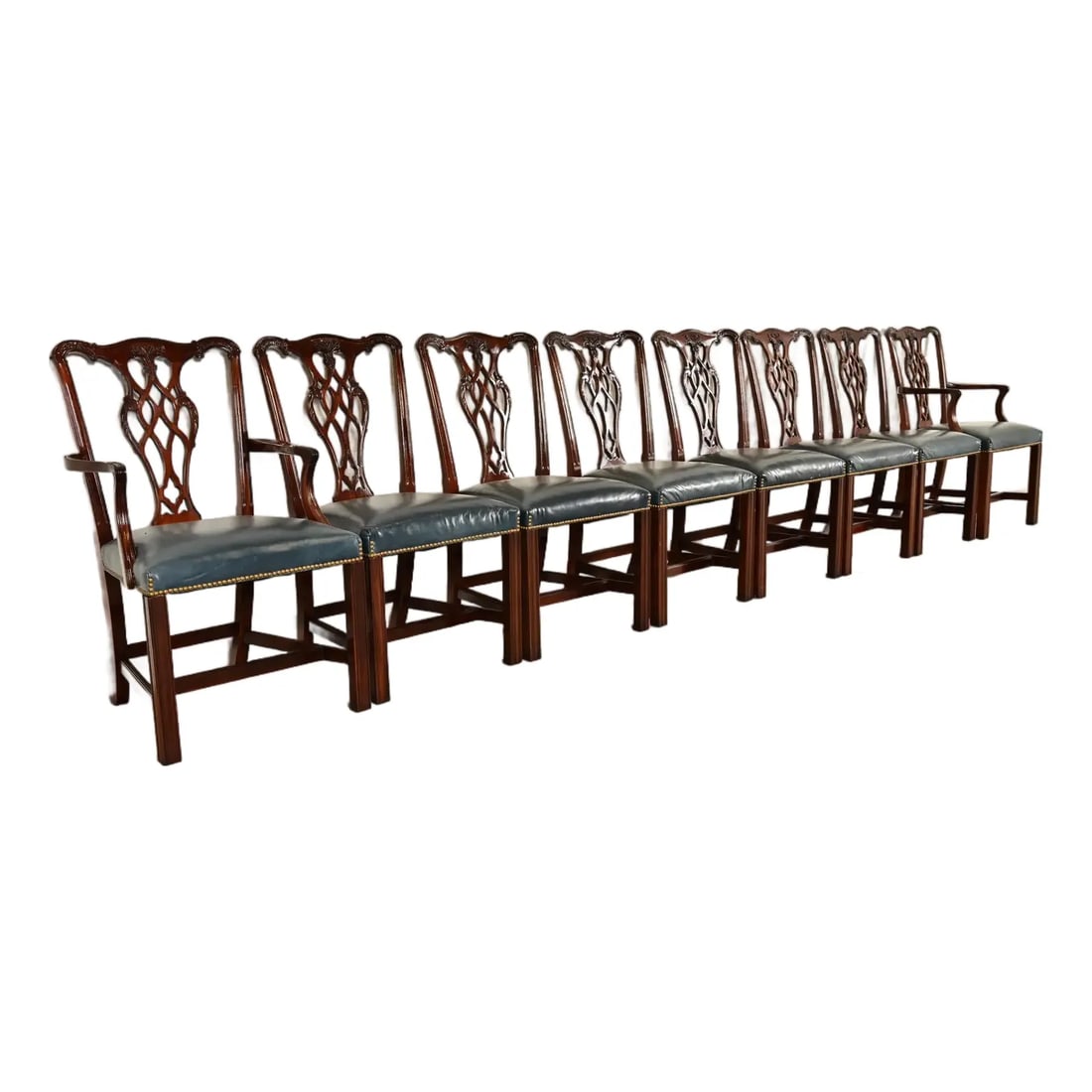 Councill Craftsmen Georgian Carved Mahogany Dining Chairs, Set of Eight: A gorgeous set of eight Georgian or Chippendale style dining chairs By Councill Craftsmen USA, Circa 1980s Carved solid mahogany frames, with brass studded blue leather seats. Measures: Side chairs - 