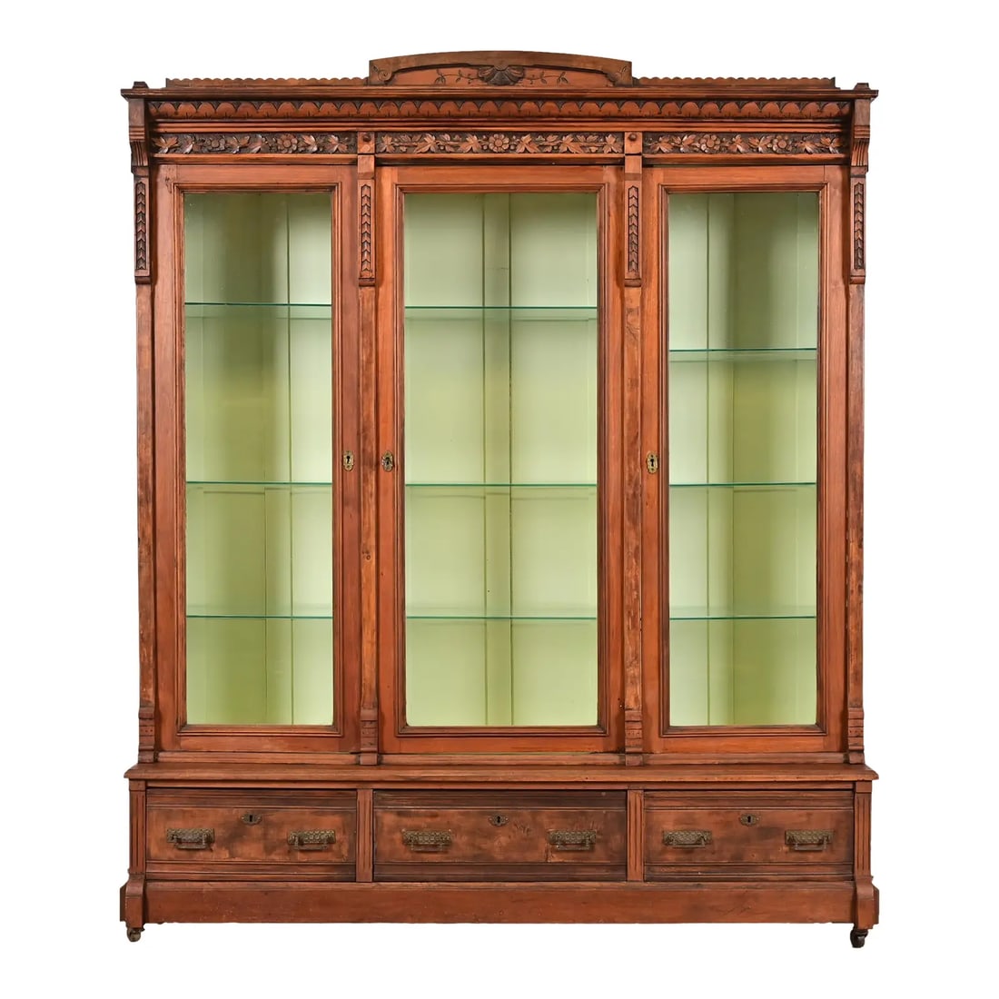 Herter Brothers Style Antique Eastlake Victorian Carved Walnut Triple Bookcase or Display Cabinet: A gorgeous antique Eastlake Victorian triple bookcase cabinet or display cabinet In the manner of Herter Brothers USA, Late 19th Century Carved walnut, with glass front doors, light green lacquered in
