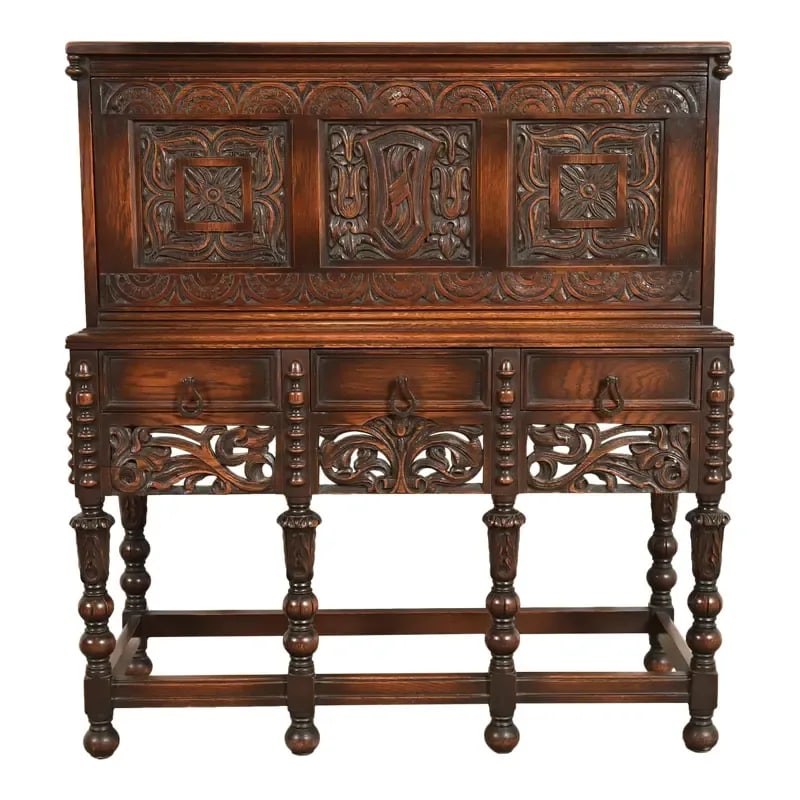 Lifetime Furniture Antique English Jacobean Carved Oak Drop Front Secretary Desk, Circa 1920s: A gorgeous antique English Jacobean or Renaissance Revival style drop front secretary desk By Lifetime Furniture USA, Circa 1920s Ornate carved oak, with original brass hardware. Measures: 42"W x 17.2