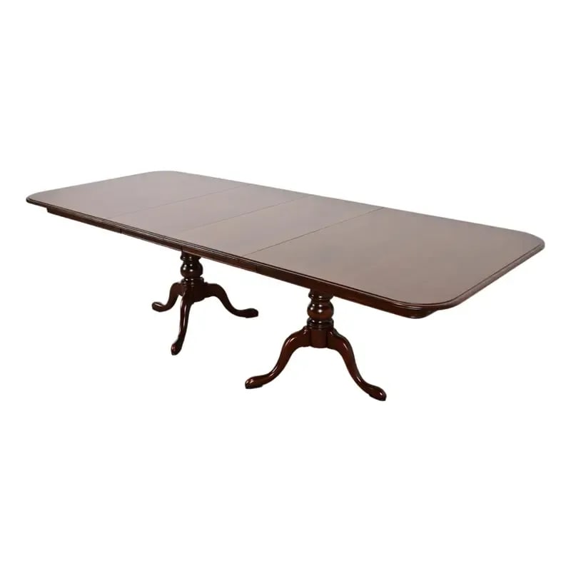 Henkel Harris Style Georgian Solid Cherry Wood Double Pedestal Extension Dining Table: An exceptional Georgian, Chippendale, or Queen Anne style solid cherry wood double pedestal extension dining table In the manner of Henkel Harris USA, Late 20th Century Measures: 66.5"W x 42"D x 29"H.