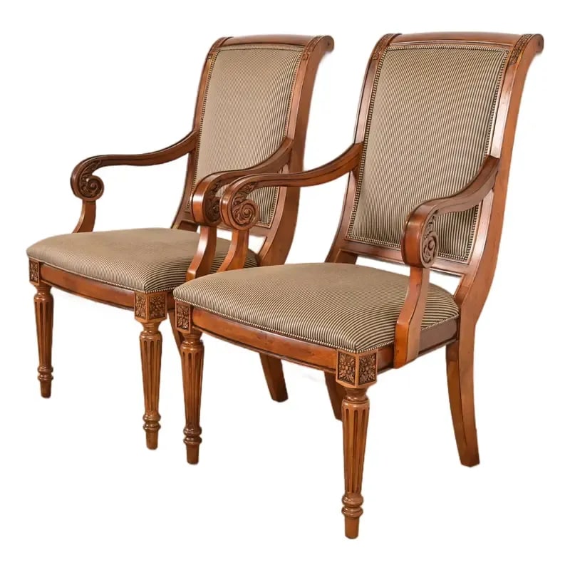 Ethan Allen French Regency Louis XVI Carved Cherry Wood Upholstered Armchairs, Pair: A gorgeous pair of French Regency Louis XVI style armchairs or dining captain chairs By Ethan Allen Circa Late 20th Century Beautiful carved cherry wood, with upholstered seats and backs. Measures: 25