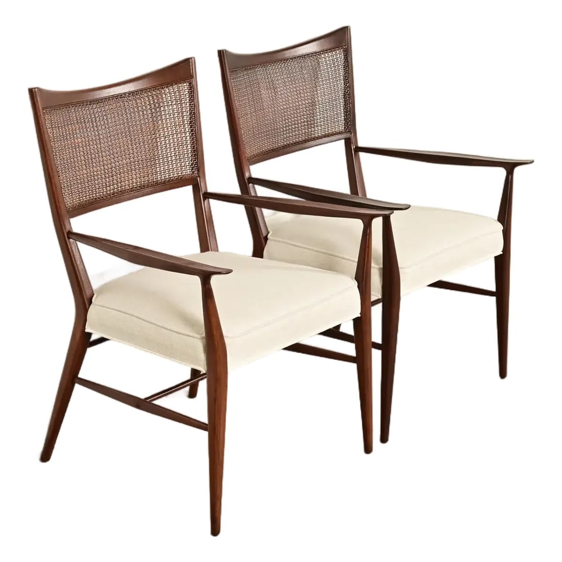 Paul McCobb Irwin Collection Mid-Century Modern Sculpted Walnut Cane Back Armchairs: A gorgeous pair of Mid-Century Modern armchairs or dining captain chairs By Paul McCobb for Directional and produced by Calvin Furniture, "Irwin Collection" USA, 1950s Sculpted walnut frames, with can
