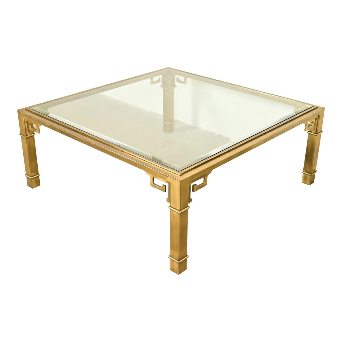 Mastercraft Hollywood Regency Greek Key Brass and Glass Cocktail Table, 1970s: An exceptional mid-century modern Hollywood Regency coffee table or cocktail table By Mastercraft USA, 1970s Brass frame with Greek Key design, and beveled glass top. Measures: 42"W x 42"D x 17"H. Goo