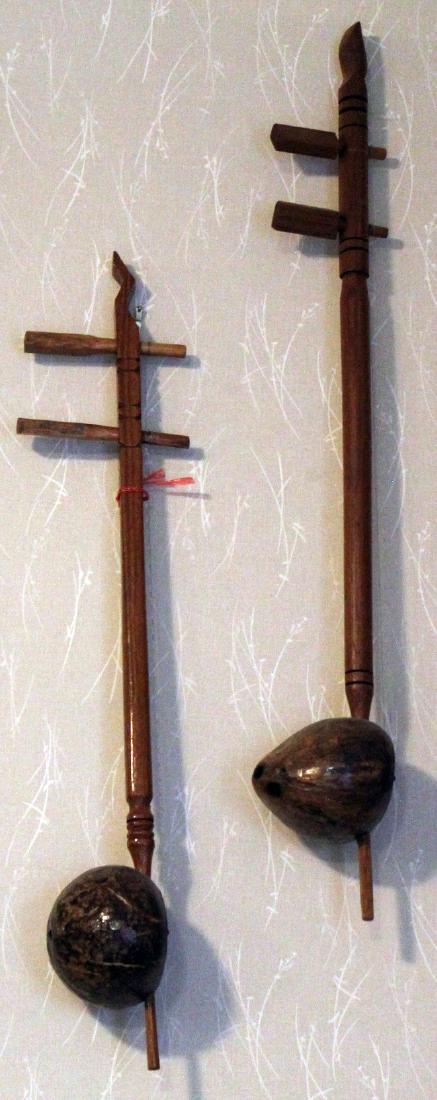 2 traditional 2 string Chinese instruments; 4" x 25" & (1 of 2)