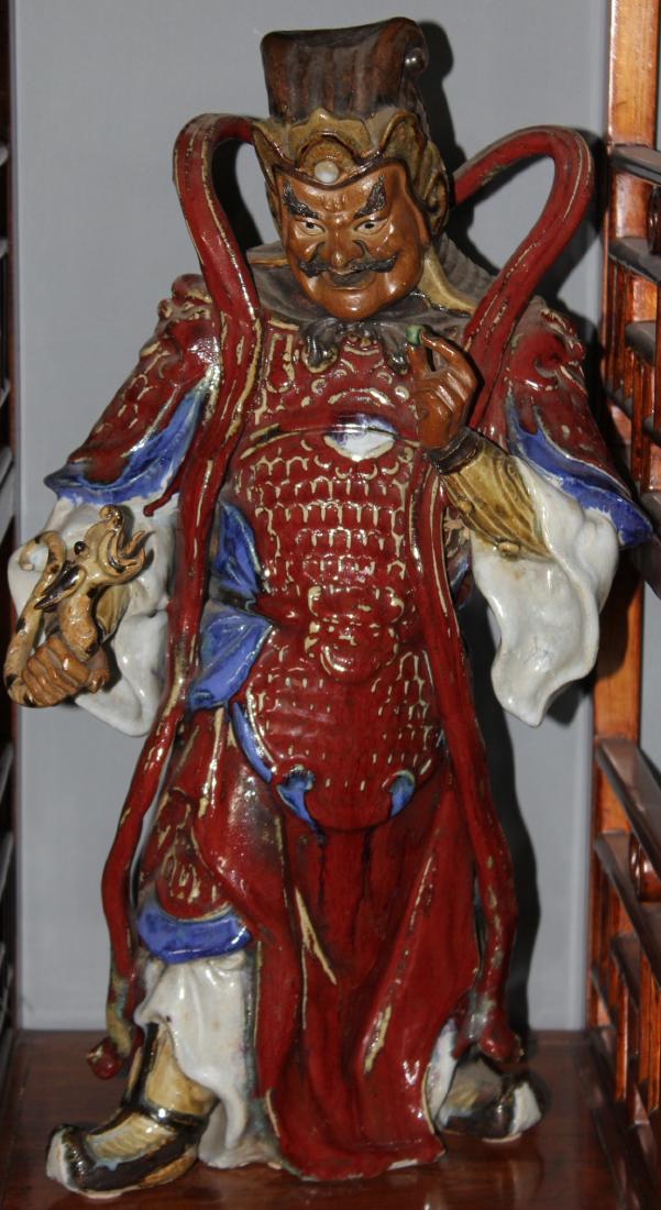 Two Chinese ceramic red glazed guardian figures, modern; (1 of 2)