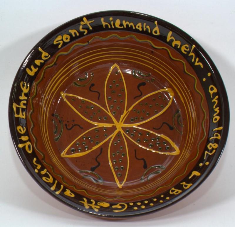 Breininger Pottery decorated slipware bowl,: Breininger Pottery decorated slipware bowl, with PA German saying 1982, 13" diameter, inside glazed, outside not