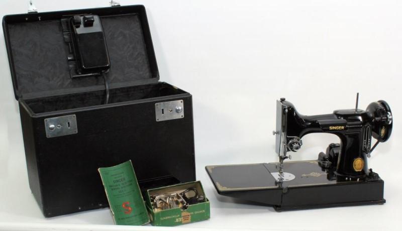 Singer Portable Electric Sewing Machine 221-1 with: Singer Portable Electric Sewing Machine 221-1 with case, attachments, cord and manual. Case measures 11" high x 14" long. Serial number on bottom is AK584387.