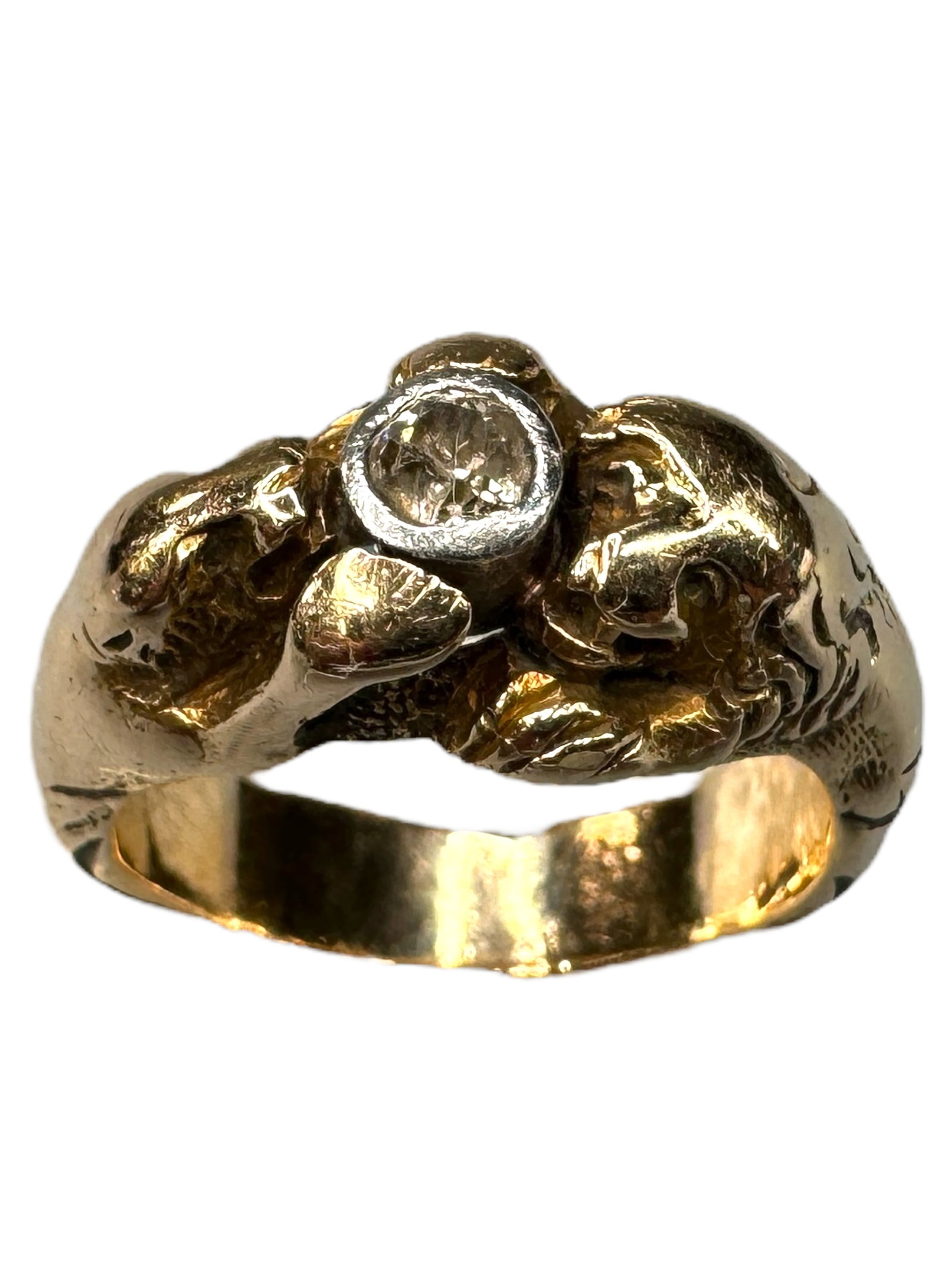 14k Lion & Lioness Diamond Ring: Tested as 14k, but unmarked. Showcases an artisan band of a Lion and Lioness on each side of a bezel set 3.5mm natural mine cut diamond. Diamond has girdle into table damage. Size 7.5. Weighs 7.47 DWT