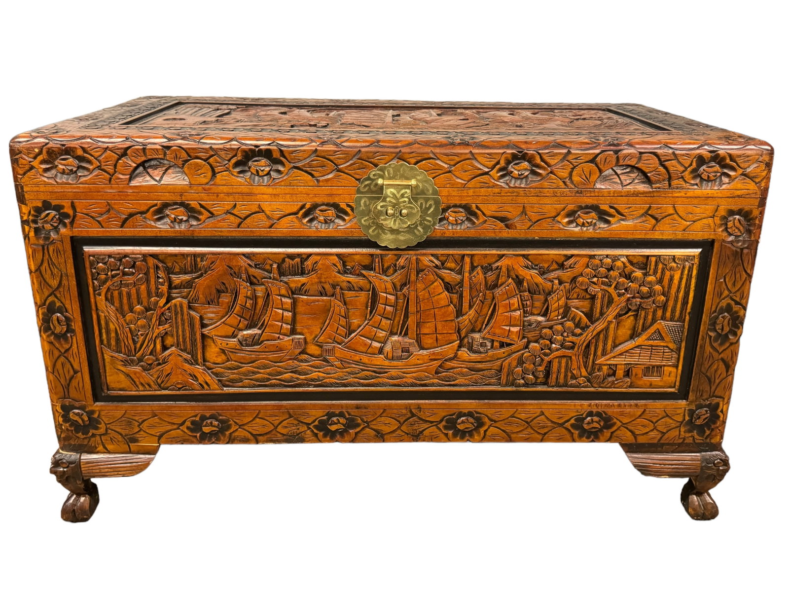 Gorgeous Carved Teak Camphor Wood Asian Chest: Beautifully carved Asian chest appears more modern with teak and possibly camphor woods. Depicts ships and Asian coastal scenes with carved feet. Brass latch and hardware. Measures 23.5 inches tall by