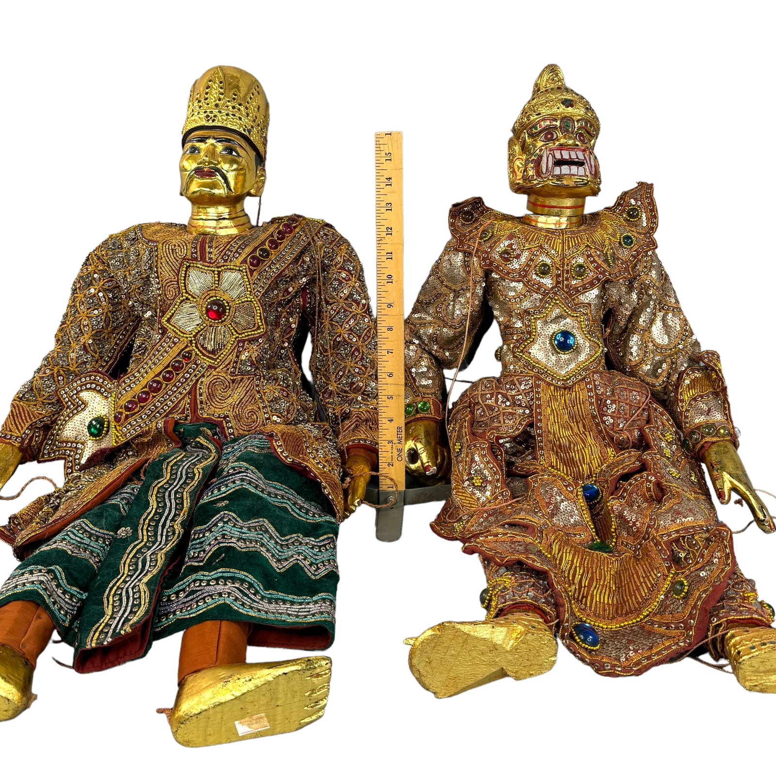 Pair Burmese Decorated Carved Wood Marionettes: Outstanding vintage pair of Large carved wood Burmese style marionettes. Gorgeous Highly adorned and decorated luxury clothing with glass beads and sequins. Hand painted gilt limbs and faces. Roping m