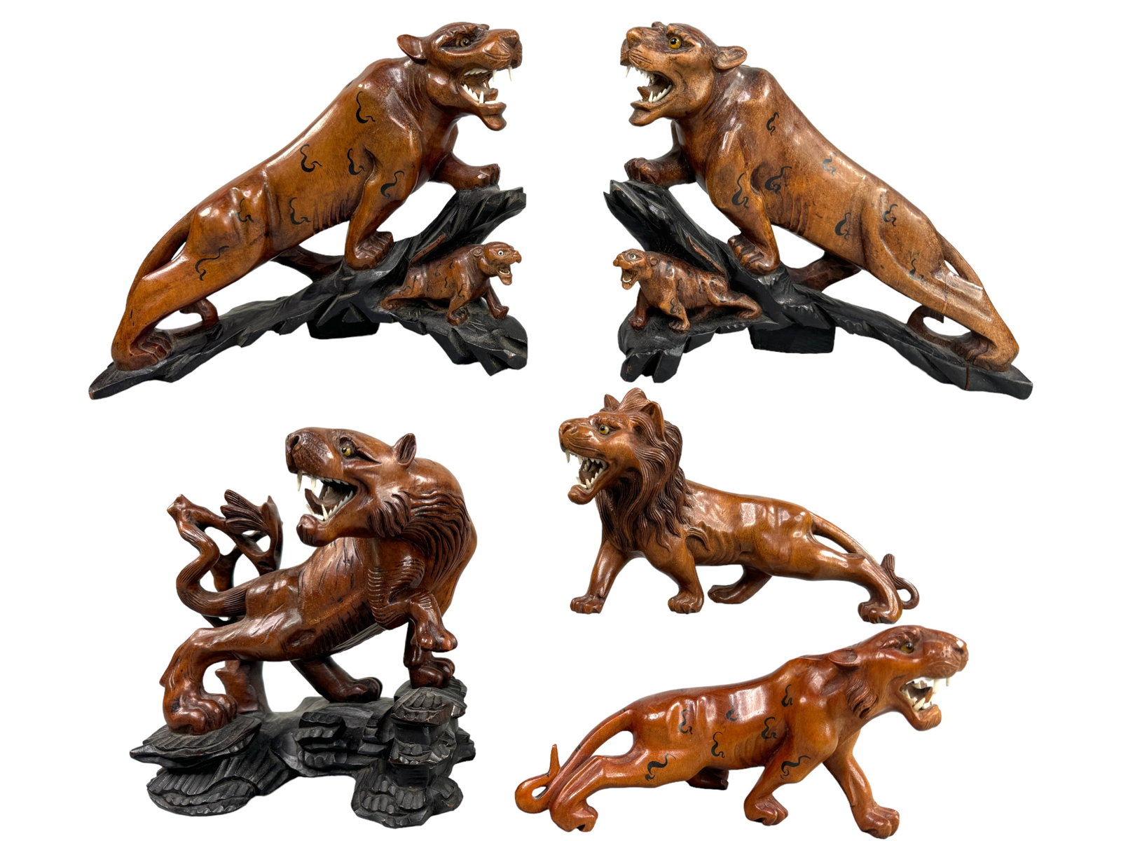 Carved Wood Tigers, Lion, Bone Teeth, Glass Eyes: An oppositional pair of facing tigers with bone teeth standing 8 inches tall, A singular growling tiger stands 8 inches, a singular lion is 4.5 inches tall and a lone tiger is also 4.5 inches tall. Mo