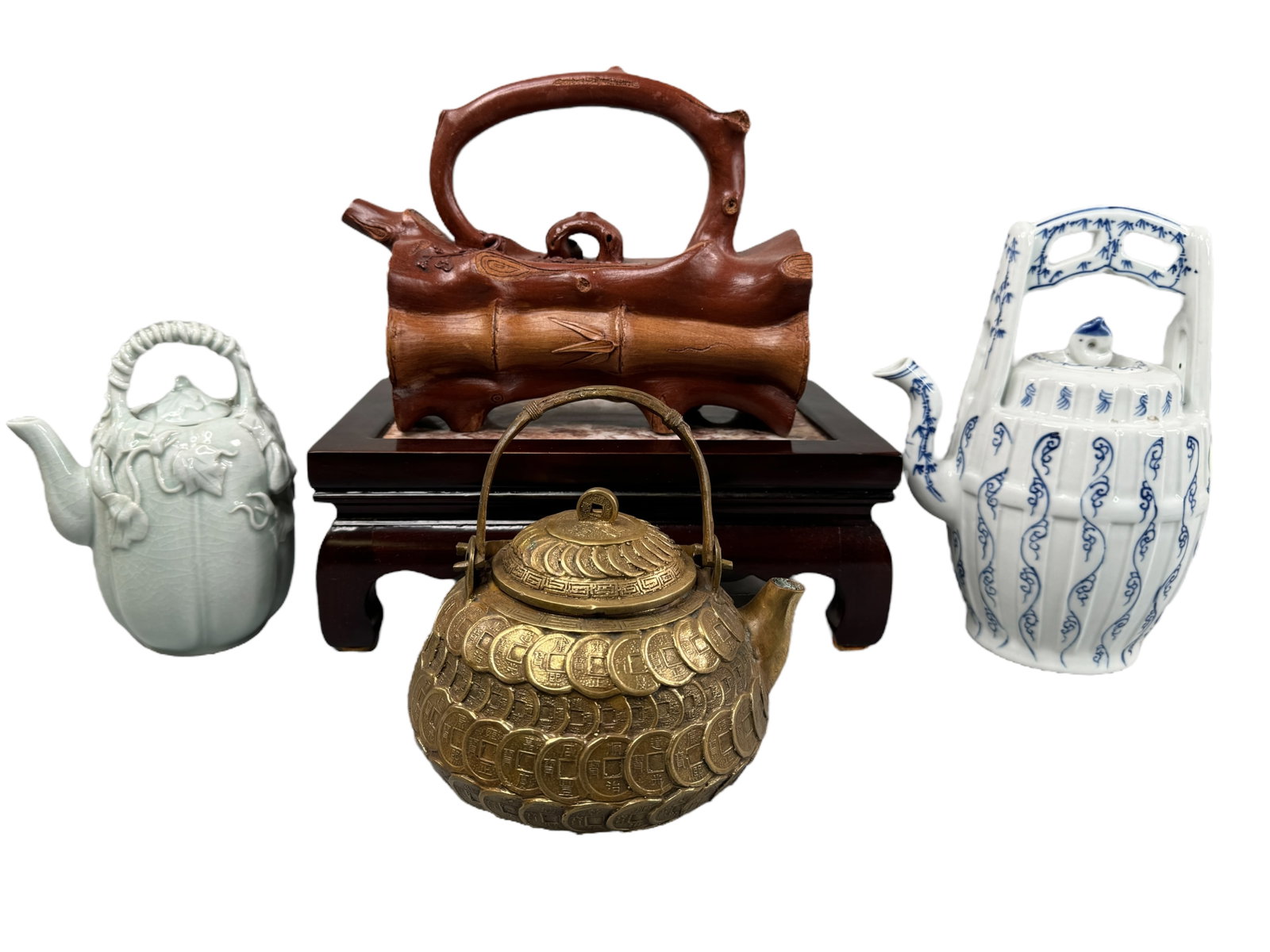 4 Unique Chinese Collectable Tea Pots: Pottery bamboo log style teapot, vintage blue and white pot, yen composed tea pot and a celadon color porcelain pumpkin figural teapot. Largest is 7 x 8 inches. Wood and marble stand included. Most Po