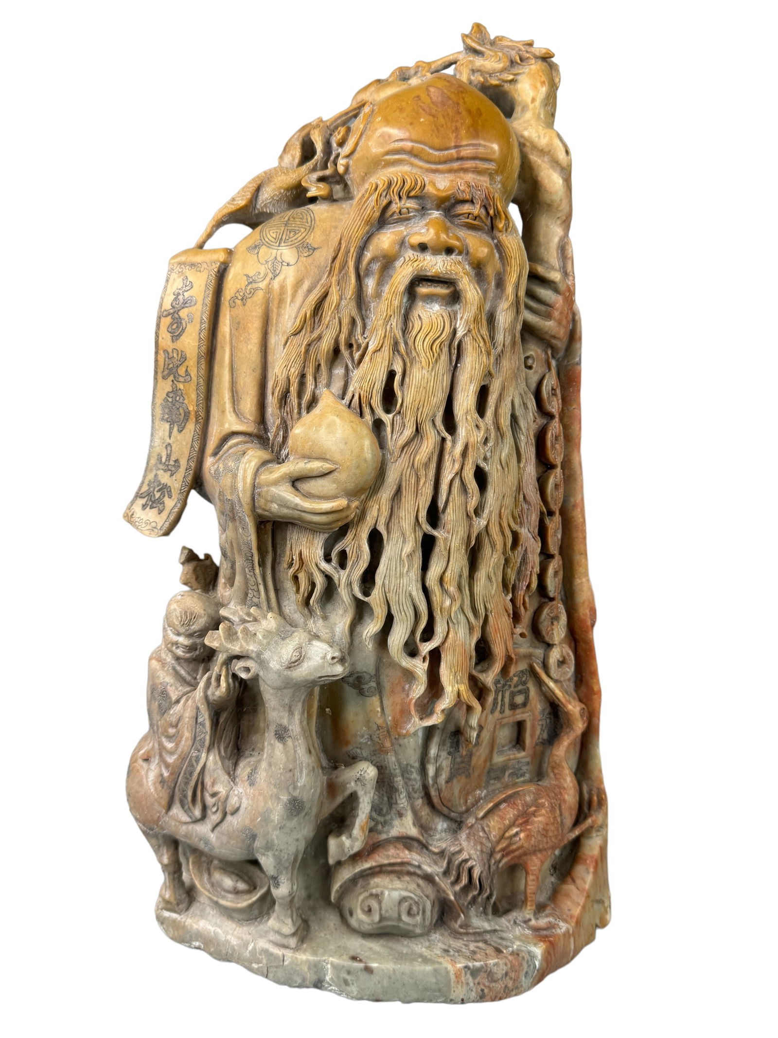 Large Intricate Carved Soapstone Shou Xing: Large carved soapstone statue of longevity god Shou Xing. Intricate and plentiful in details from the etched designs in the garments to the carved boy, deer, and crane. Measures 17 x 8.5 x 4 inches.**