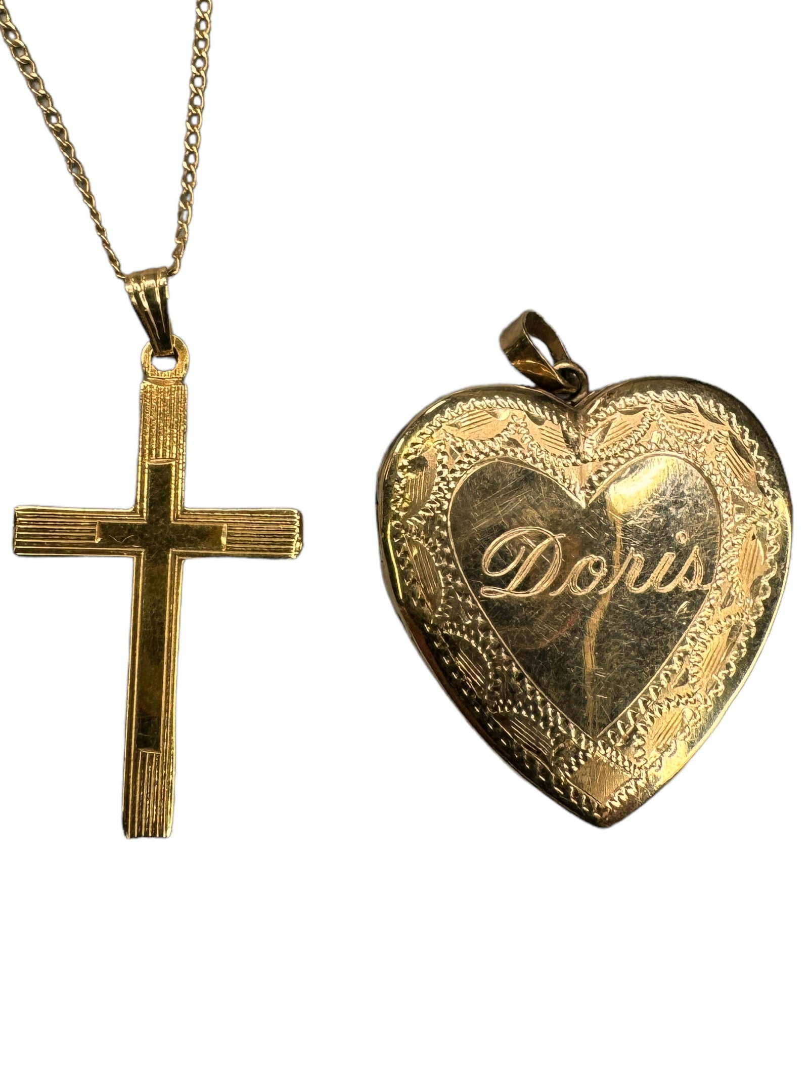 14k Cross w/ Chain & A Monogrammed Heart Locket: CREED marked 14k 1 inch cross pendant on an 18 inch 14k dainty chain. A 14k marked 1 inch heart locket with etched design monogrammed DORIS. Both interior sides have picture holds. Both weigh 4.02 DWT