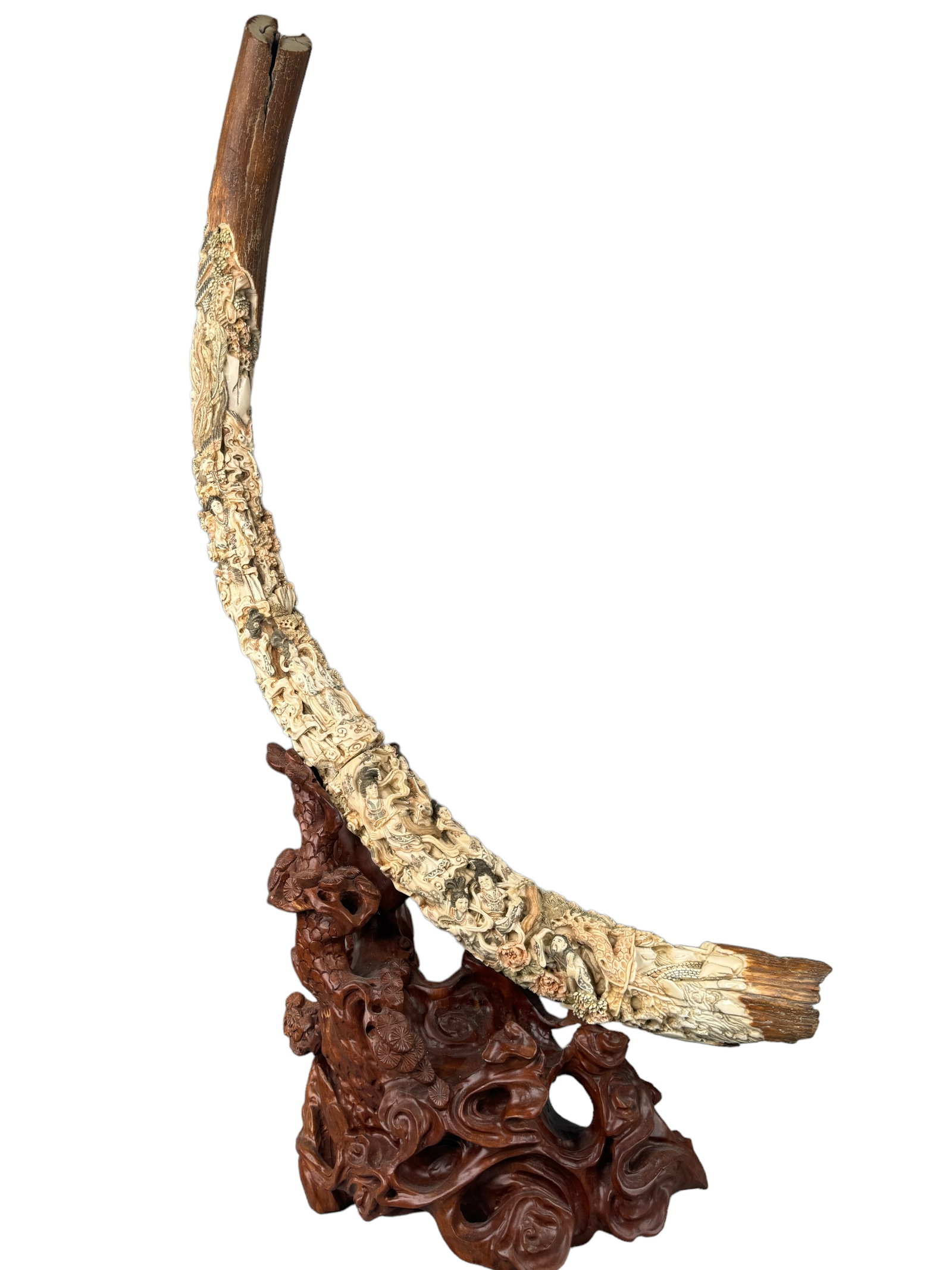 Intricately Carved Mammoth Tusk W/ Stand: The details are admirable with maidens, cranes, phoenix style birds, houses, trees, florals and more. Has intricate etched ink details with light red, green, and black coloration. It appears to have b