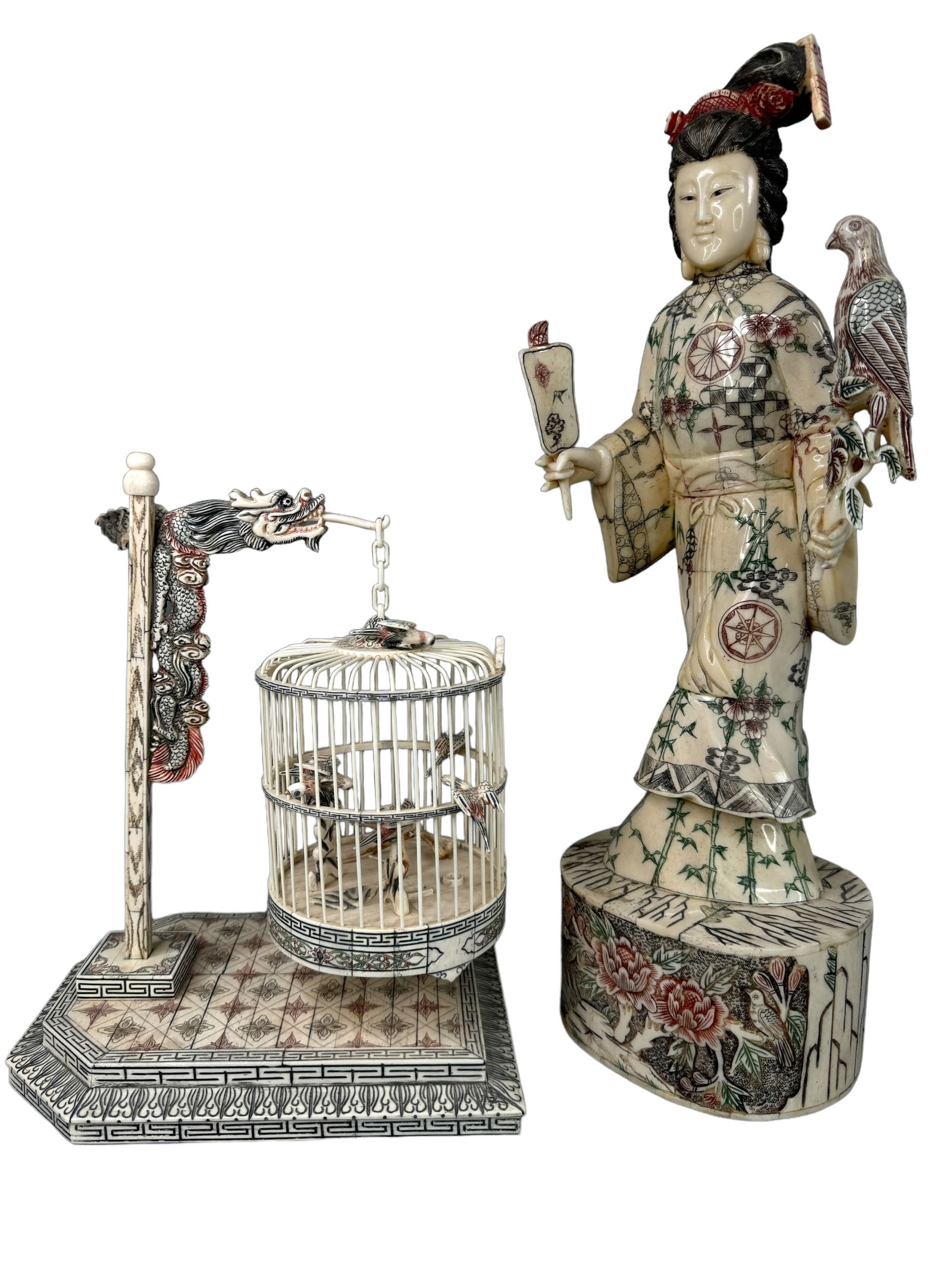 Lovely Carved Bone Panel Woman With Birdcage: A Beautifully carved and pieced bone panel pair of statues. Highly detailed with colored etching. One is of a woman with a fan and bird standing 20 inches tall. Her fan is loose to be reattached prope