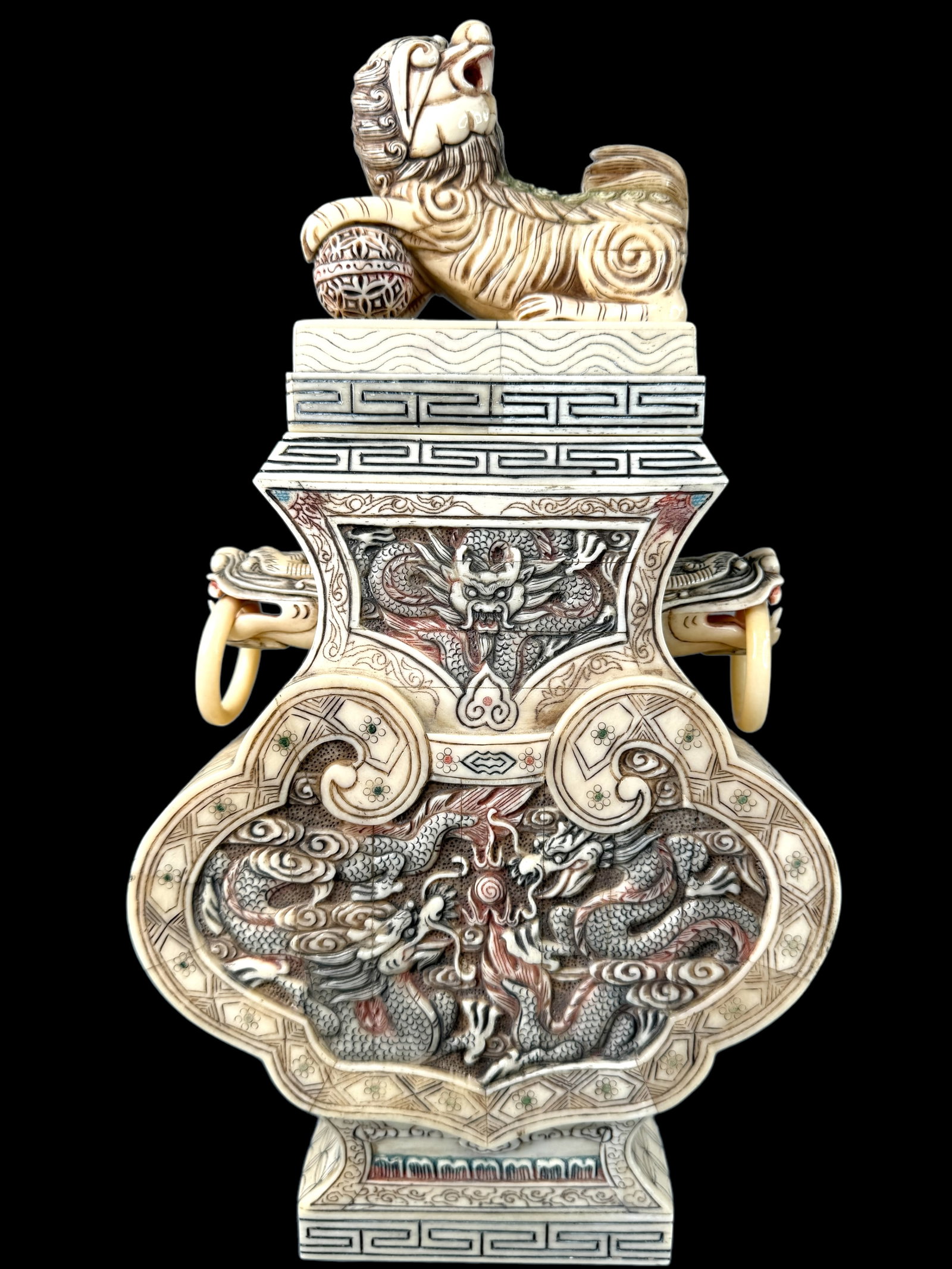 Vintage Signed Bone Panel Foo Lion Urn: Intricately carved bone panel Asian urn with foo lion figural lid. Highly detailed carved scenes of dragons. Figural ringed handles and etched coloration texture give this piece a stately appearance. 