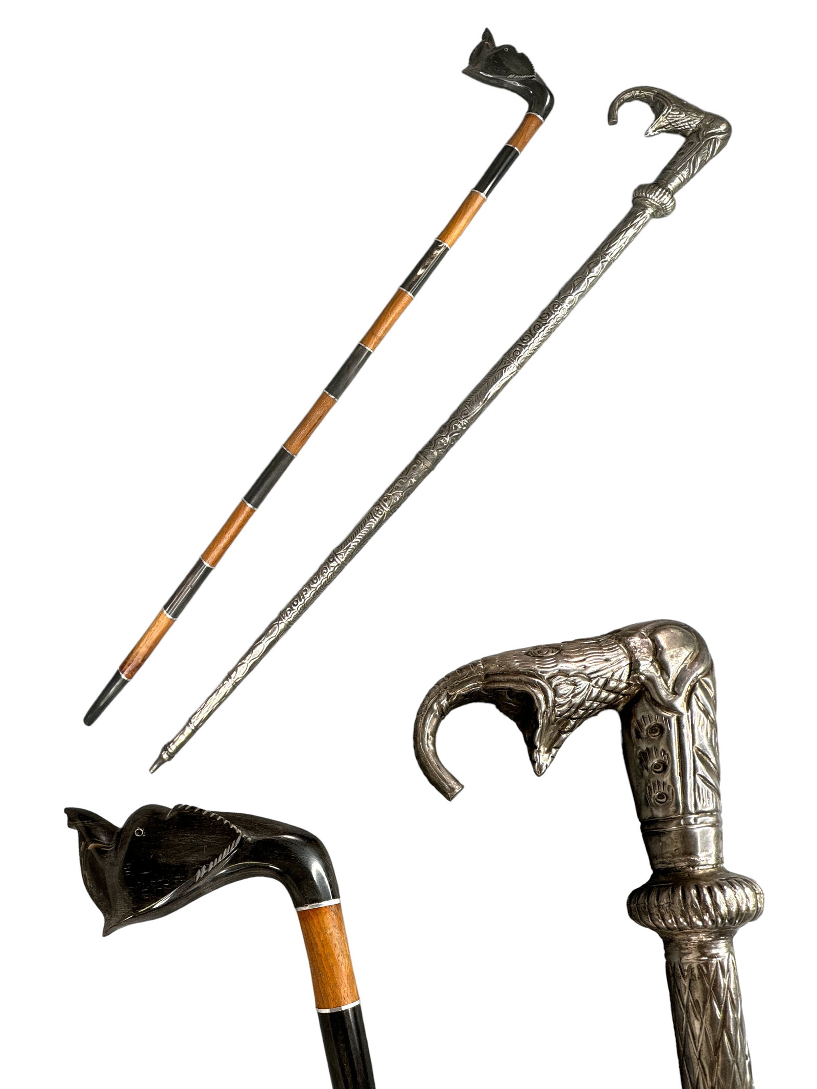 Unique Asian Walking Canes, Silver Plate, Horn: Appears as horn carved elephant handle with bands of wood and is 34 inches tall, presumed silver plated hollow cane is 35 inches tall.