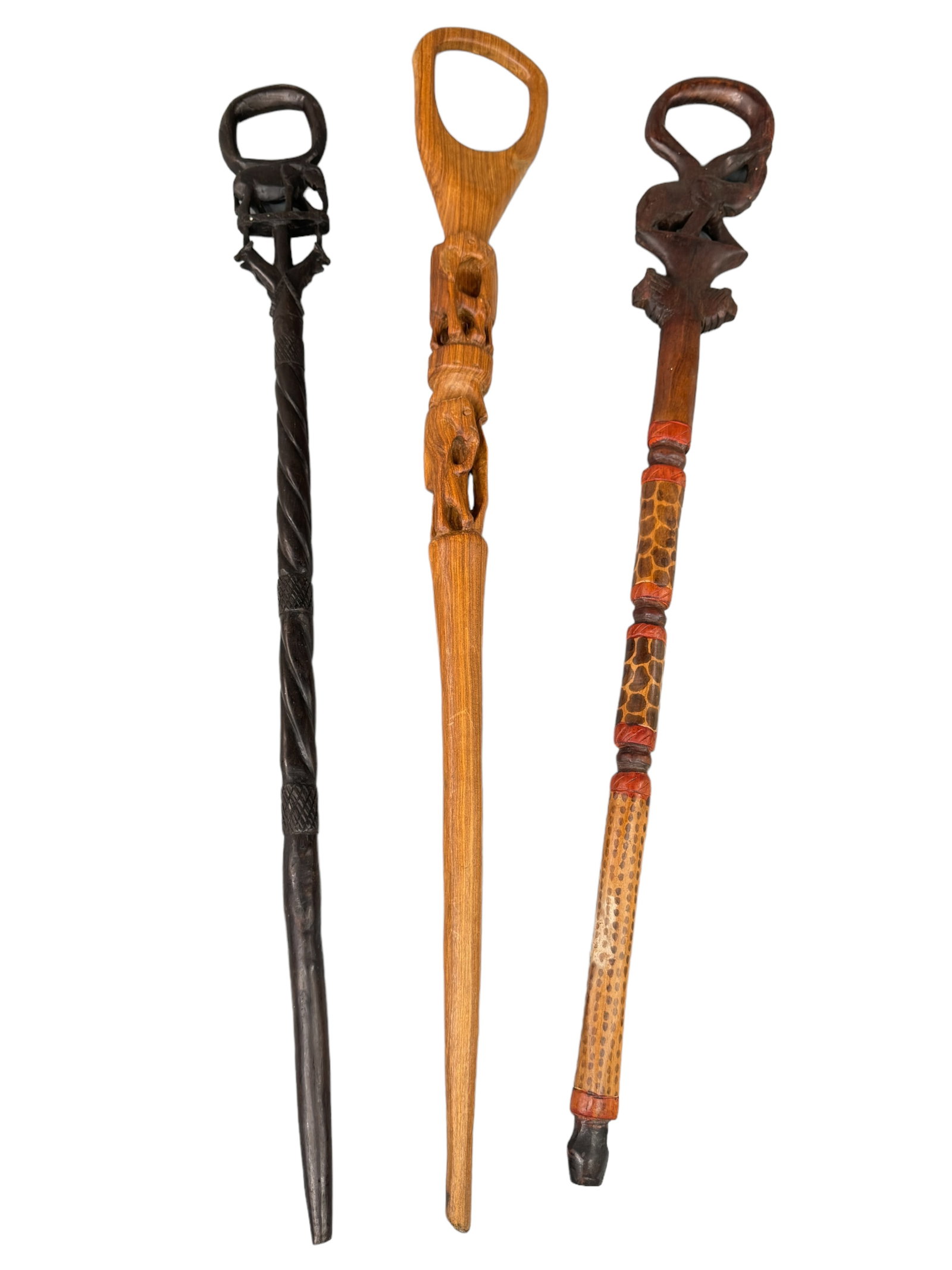 3 African / Asian Style Carved Walking Sticks: Elephants, painted giraffe patterns. All three appear African, one is possibly more Asian. All three appear hand carved and they average 36 inches in length.