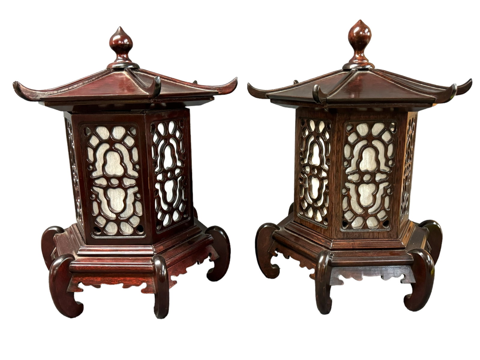Vintage Dark Cherry Wood Pagoda Lamps: Vintage dark wood pagoda shaped lantern lamps. Carved see through detail with parchment or rice paper inner shade. Both are untested. Each measures 19 x 16 inches. *** This item requires IN PERSON PIC