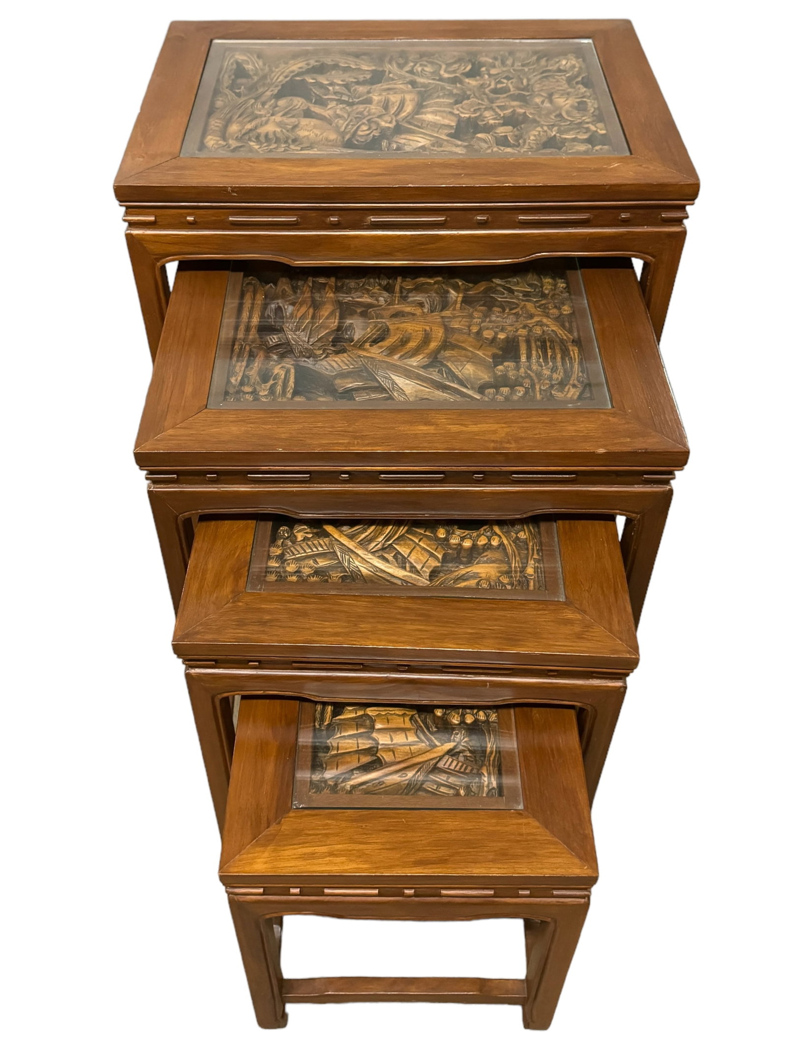 4 Carved Top Asian Nesting Side Tables: Amazing Carved wood Asian nesting side tables. beautiful carved in table top scenes of dragons, phoenix, and ships. Glass toppers on each. Completely nested the largest table is 25 x 20 x 14 inches, t
