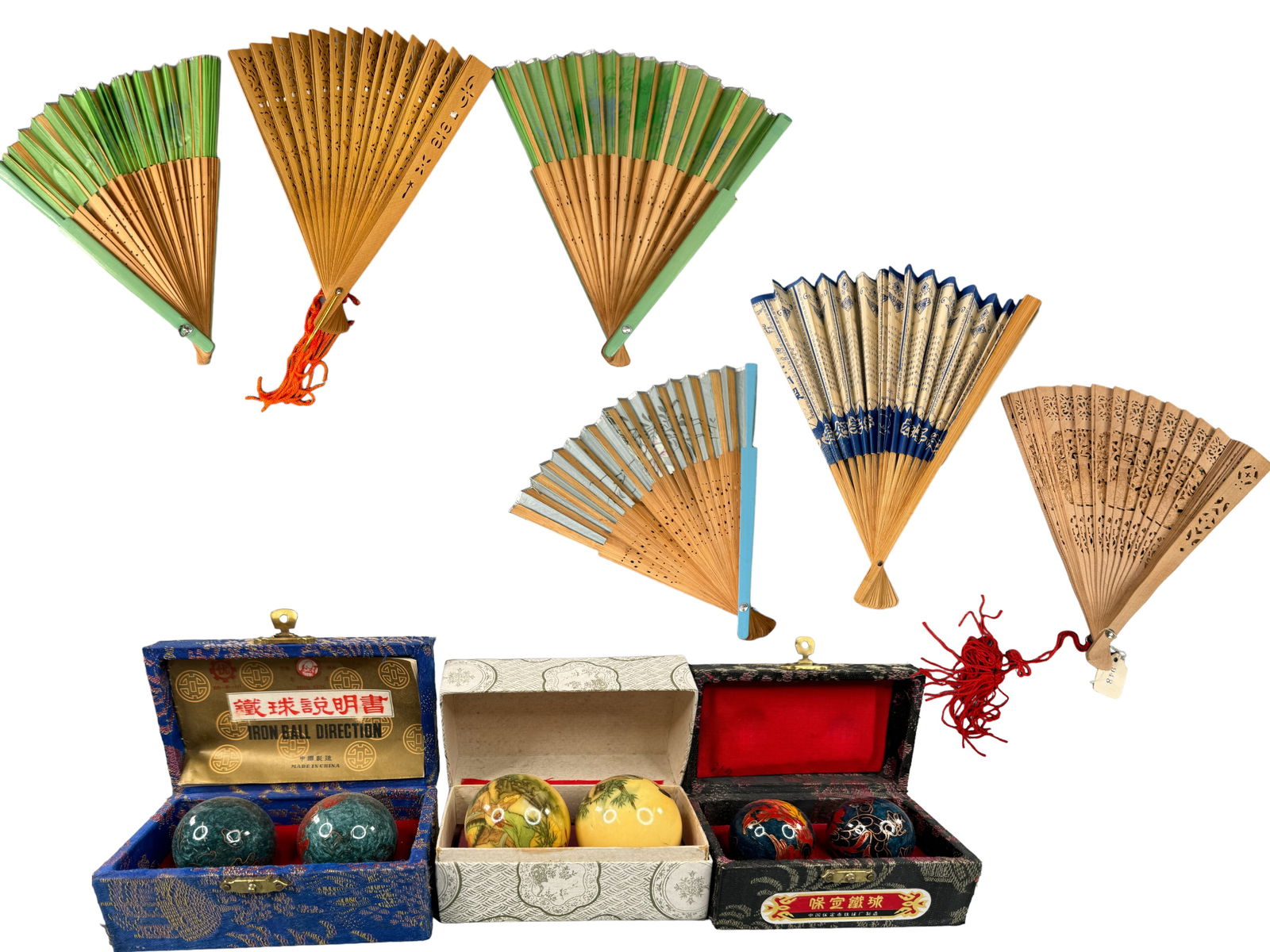 Vintage Asian Fans & Baoding Balls: 6 beautiful mid century and vintage Asian paper fans with wood, hand painted fabric, and carved cork/wood fans, bamboo or resin end caps. Two are boxed. All are under 10 inches in length. 3 pair of vi