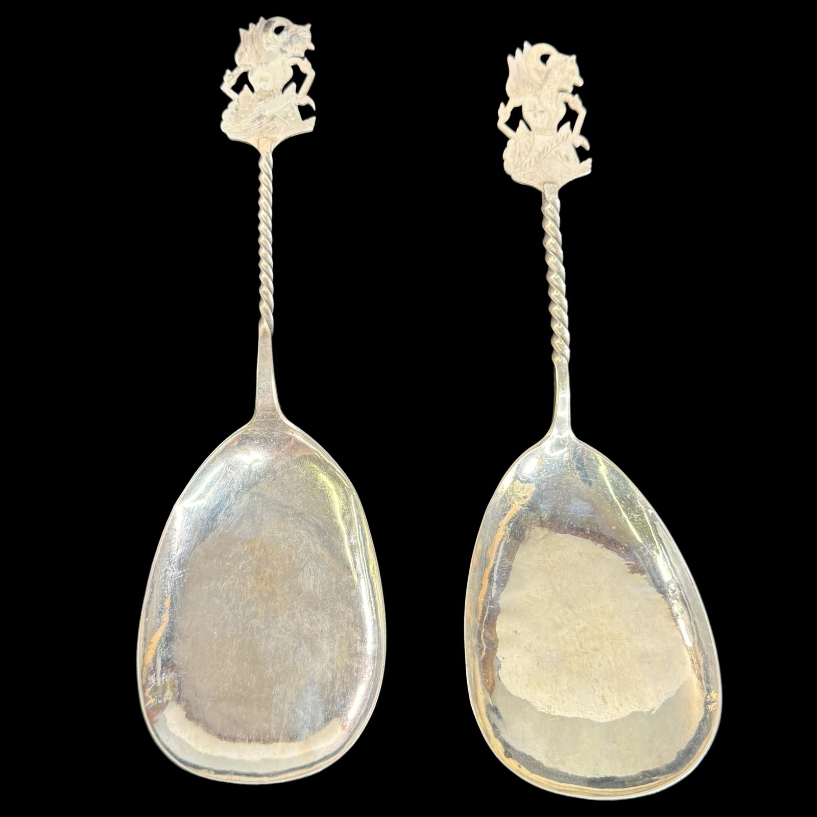 Vintage 800 Silver Asian Serving Spoons: Marked 800 silver. Burmese style character figure on the top. Large serving size. Both are 9.5 inches in length and weigh 3.45 OZT.