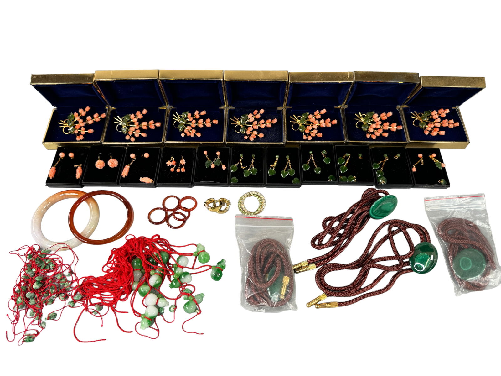 Genuine Stone, Boxed, Resale Asian Jewelry: Malachite, Glass, and possibly genuine bits of jade in gold toned jewelry. 7 boxed flower brooches, 11 boxed earrings (Most need minor and easy repairs), 4 malachite bolos PLUS. All unmarked.