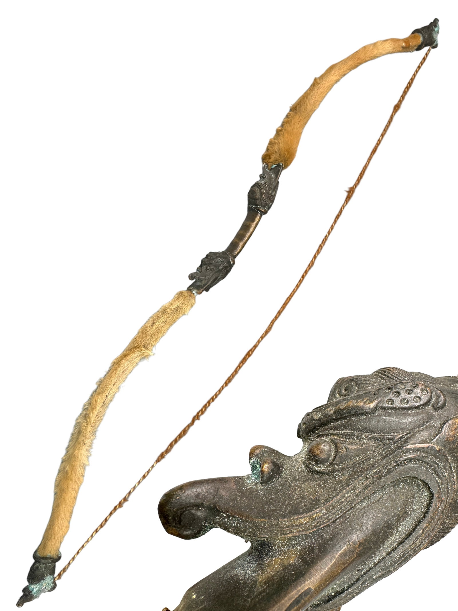 Antique Chinese Bronze Dragon Head Bow Replica: Handsome antique replica of a Chinese/Mongolia Warring Period bronze bow. Gorgeous bronze work dragon heads with inscribed characters. Genuine fur lined with a genuine hide curl string. Verdigris adds