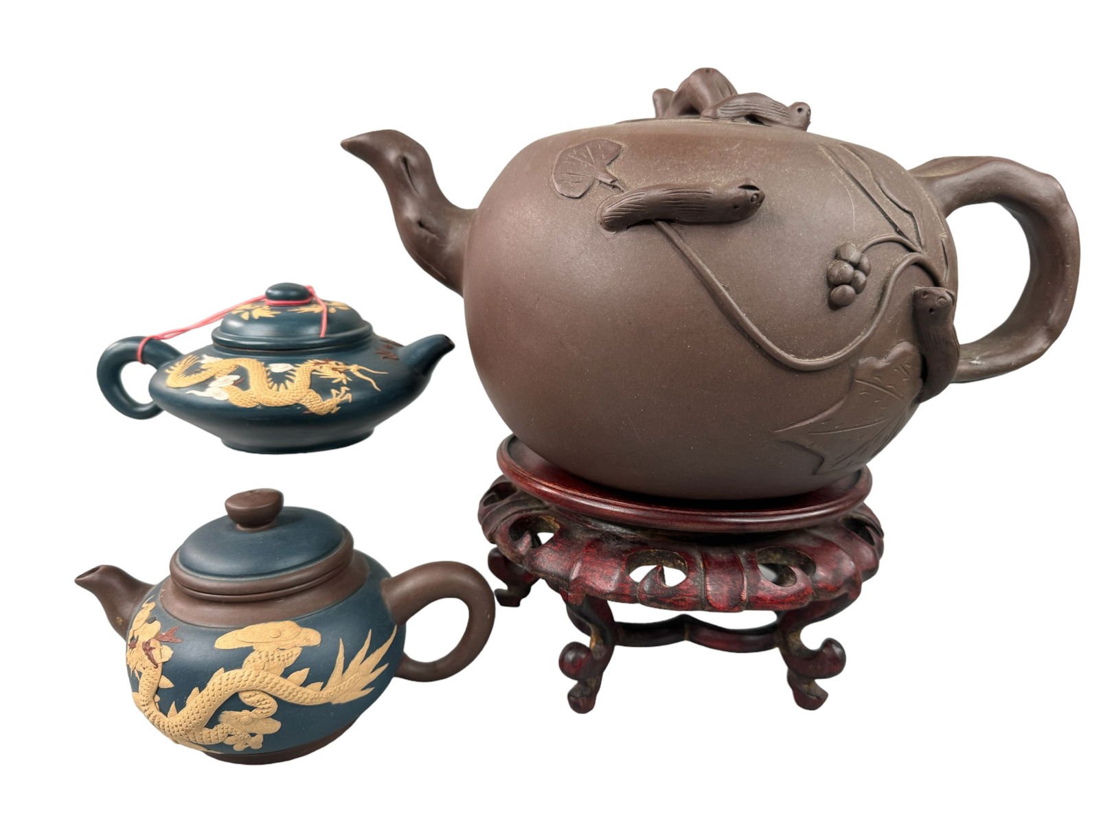 Yixing Zisha Clay Teapots, Large, Two Small: Vintage large Yixing Zisha clay pot with figural decorations. Measures 7 x 12 x 8 inches. Two smaller teapots with dragon figural tea pots. One is 4 inches tall and one is 3 inches tall.