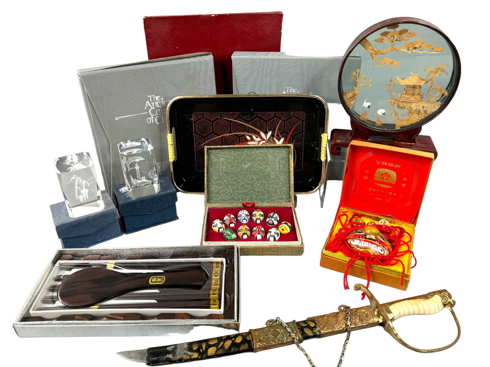 Asian Collectibles Lot, Cork Carving, Opera Masks: Cork carving with cranes and pagoda encased in glass and wood round. One hold is broken but easy repair. Stands 8.5 inches tall. Faux dragon sword with partial sheath is 16 inches. Two vintage boxed c