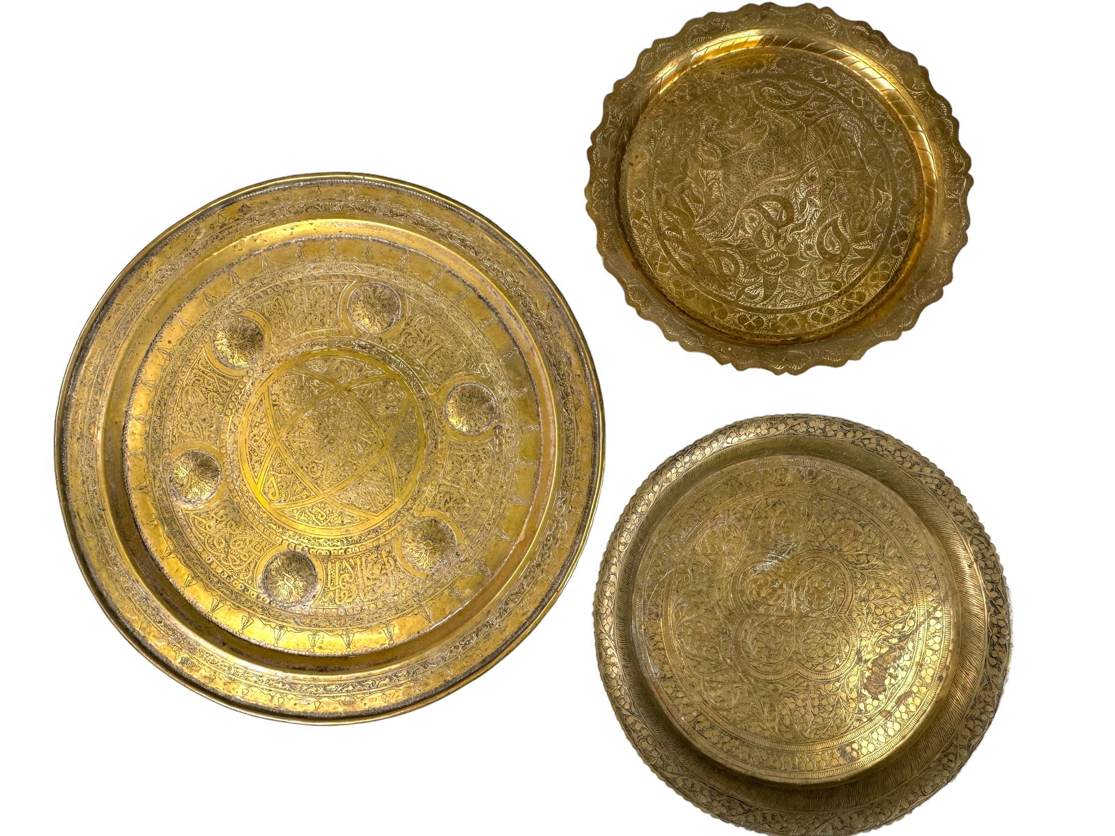 3 Etched Brass Middle Eastern Trays: 3 antique intricately etched brass round trays. All are unmarked. Largest tray has a sterling toned backing. Sizes are 16, 11.25, and 11.5 inches.