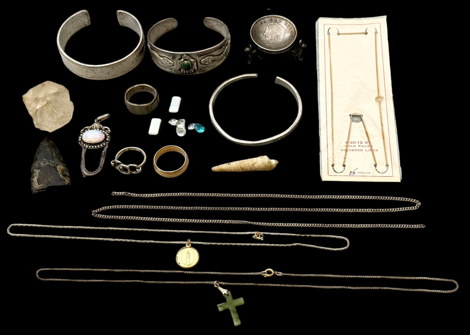 Gold Filled, Sterling, Metal, Stones Grab Bag Lot: Loose stones, possibly genuine opal. A sterling and faux glass opal pin weighing 3.36 DWT. 14k gold shell gents ring size 10. (2) unmarked rings. Quartz stone, arrowhead, white metal bangles, unmarked