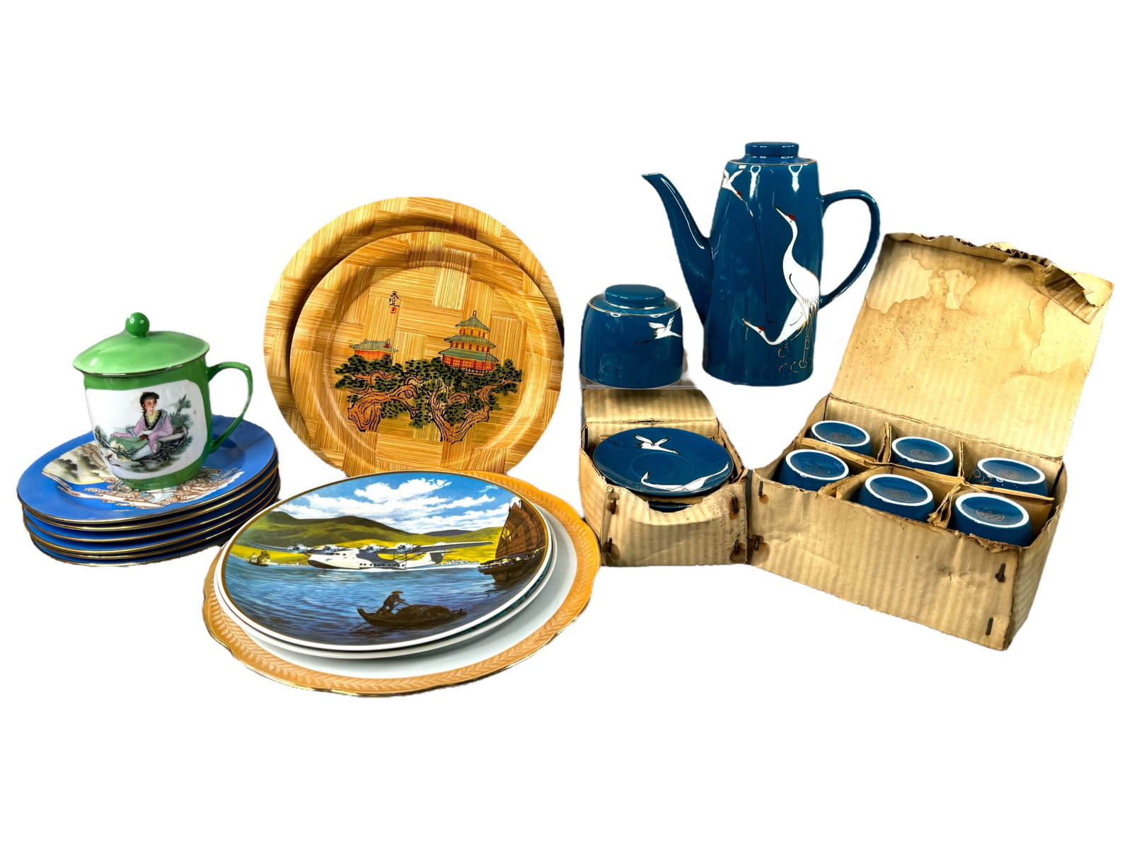 Asian Collectable Porcelain Ware: Porcelain plates including a Bauscher pan and plate, 6 matching 7 inch marked plates, 2 painted woven wood plates, a covered teacup with litho design, a marked painted and gilt accented crane tea-set;