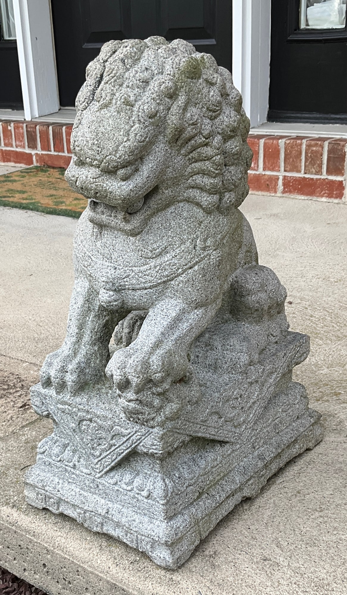 Pair of carved stone foo dogs each measuring: approximately 20 inches tall x 13.5" deep x 9 inches wide. ***Statue is extremely heavy. Auction Company will assist in loading with heavy machinery onto a truck of some sort (NO Cars or SUVs - TRUCKS