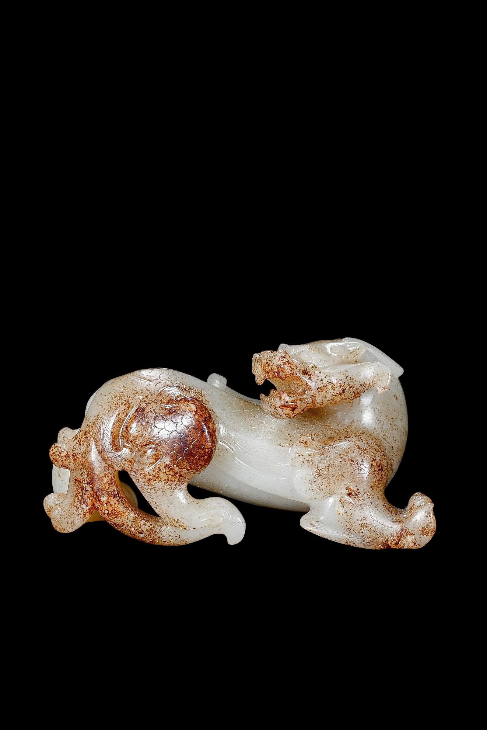 A White Jade Mythical Beast Carving with Russet Inclusions, Han, Circa 2nd C BC?C2nd C AD Pr. (1 of 9)