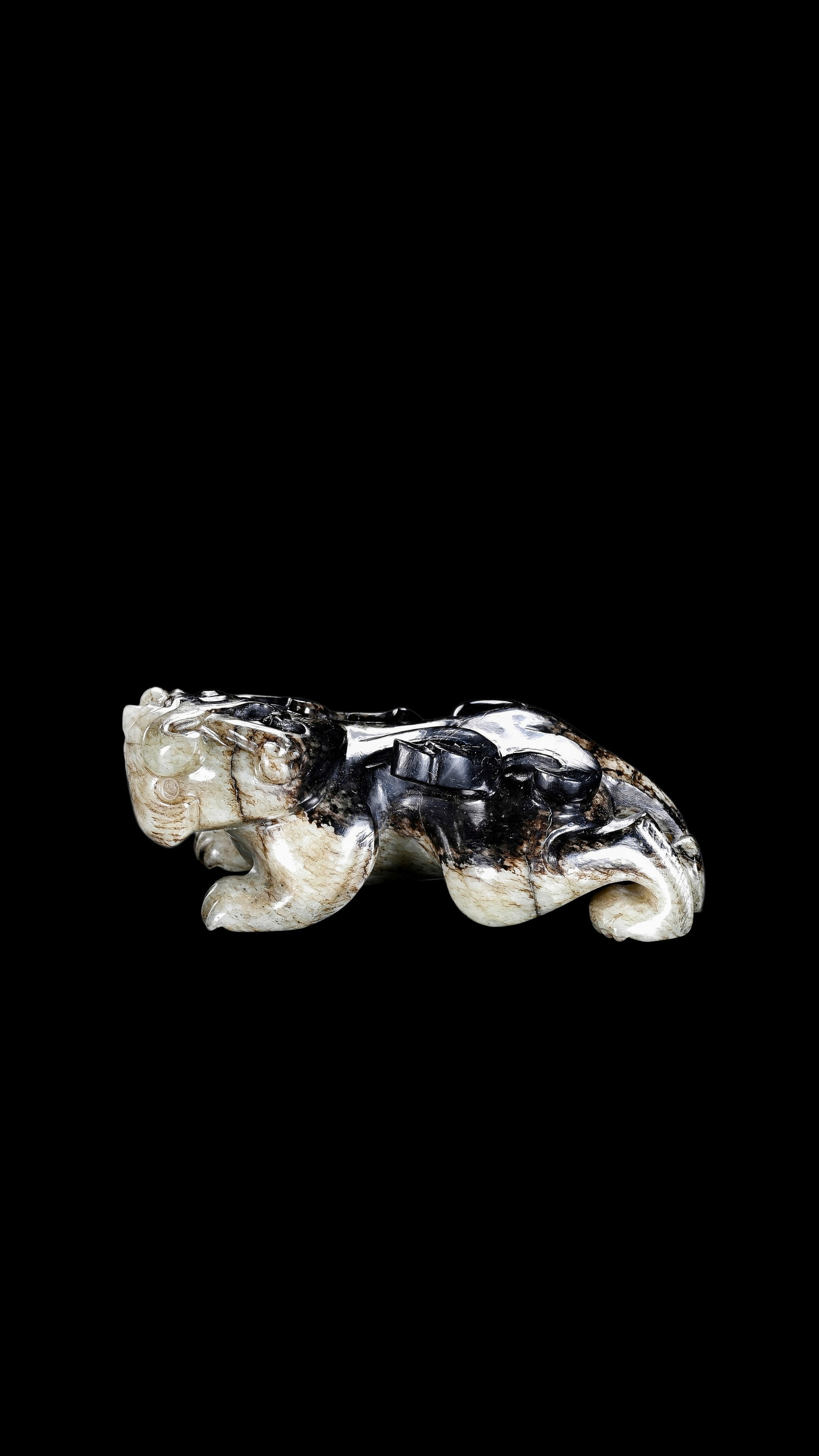 A Mottled Black & White Jade Crouching Tiger Carving, Han, Circa 2nd C BC?C2nd C AD Pr.: Size:(Height3cm Length 8cm) Shipping:EU\HK\USA Ondoor shipping estimation:75EUR Condition:(Good Condition, No Repairment Checked by UV&Strong Light, Age Traces) Terms:(It is the Buyer's responsibility